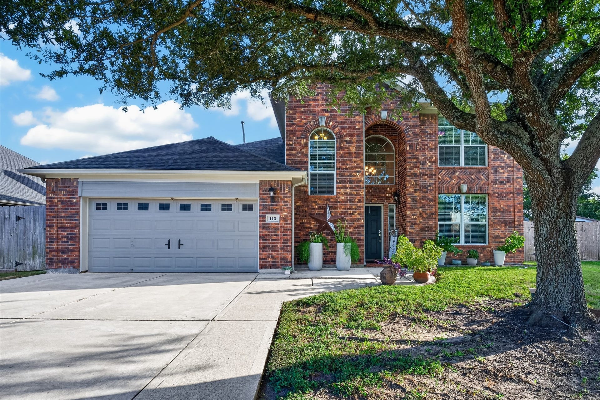 113 Erin Court, La Porte, TX 77571 Charming front exterior with manicured lawn and mature landscaping.