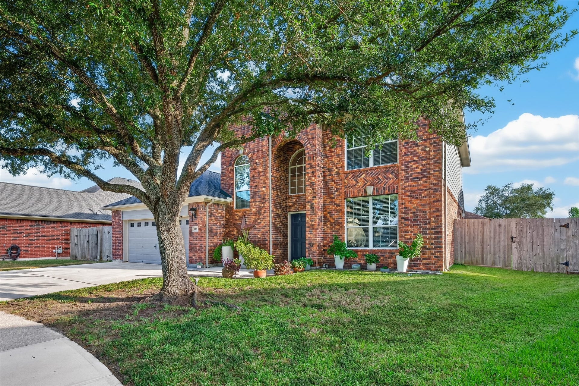 113 Erin Court, La Porte, TX 77571 Front view framed by a grand shade tree.