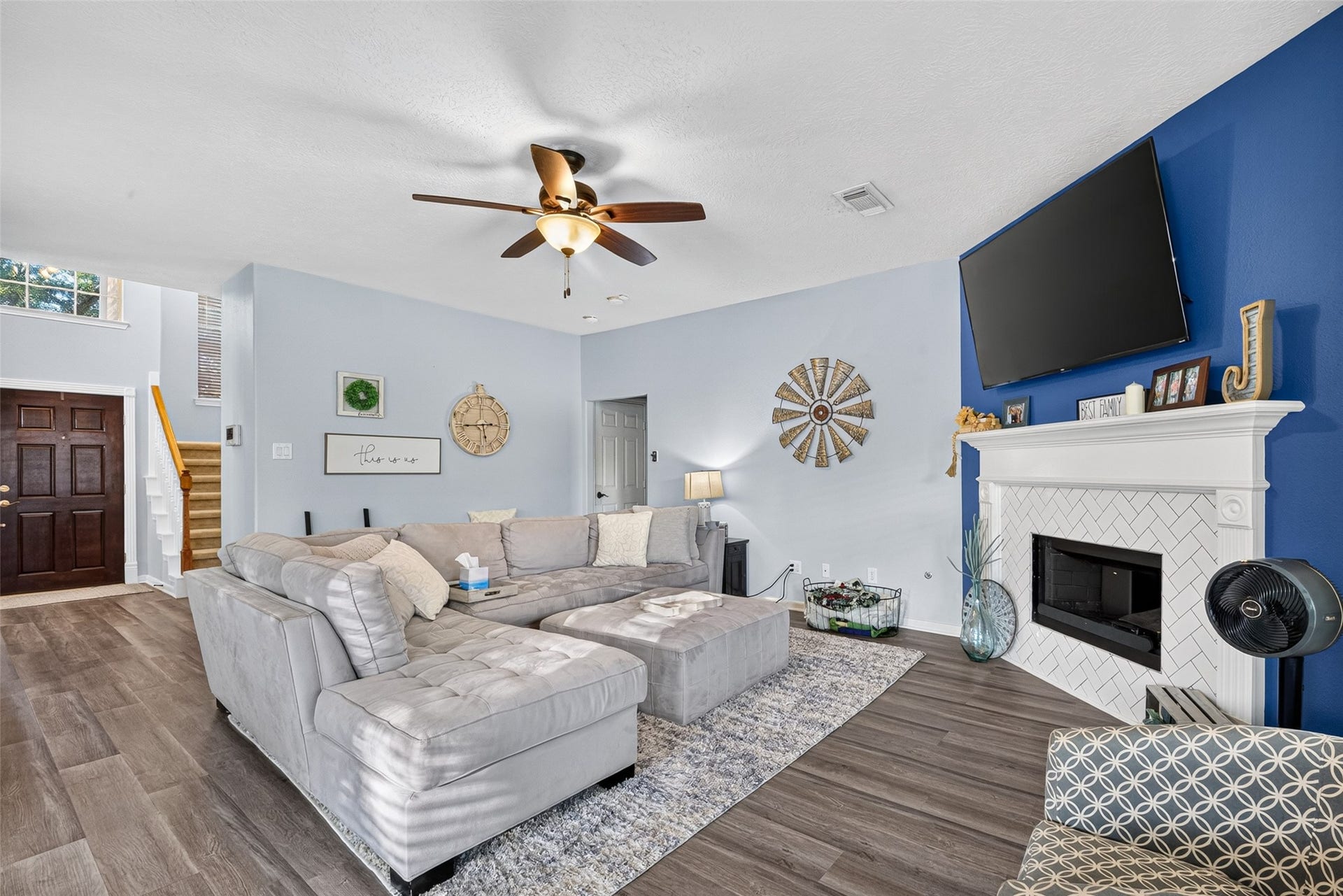 113 Erin Court, La Porte, TX 77571 Living room anchored by a cozy fireplace, open to the kitchen.
