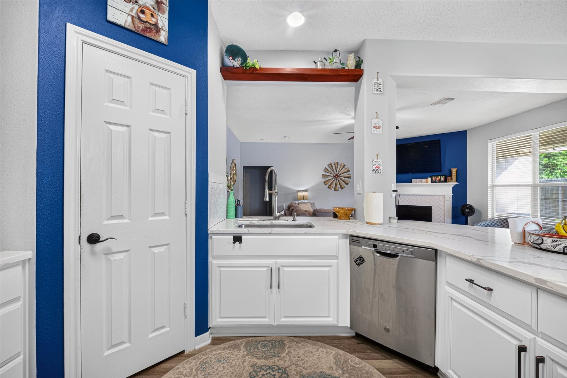 113 Erin Court, La Porte, TX 77571 Cheerful kitchen nook with a blue accent wall and garden-window sink.