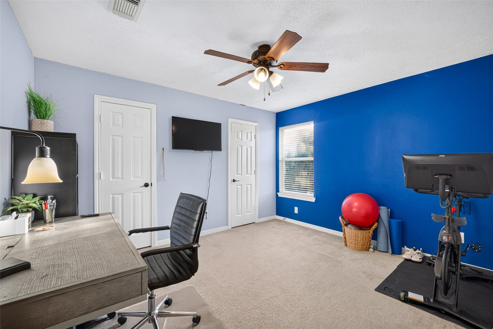 113 Erin Court, La Porte, TX 77571 Home office with a bold blue accent wall work from home in style.