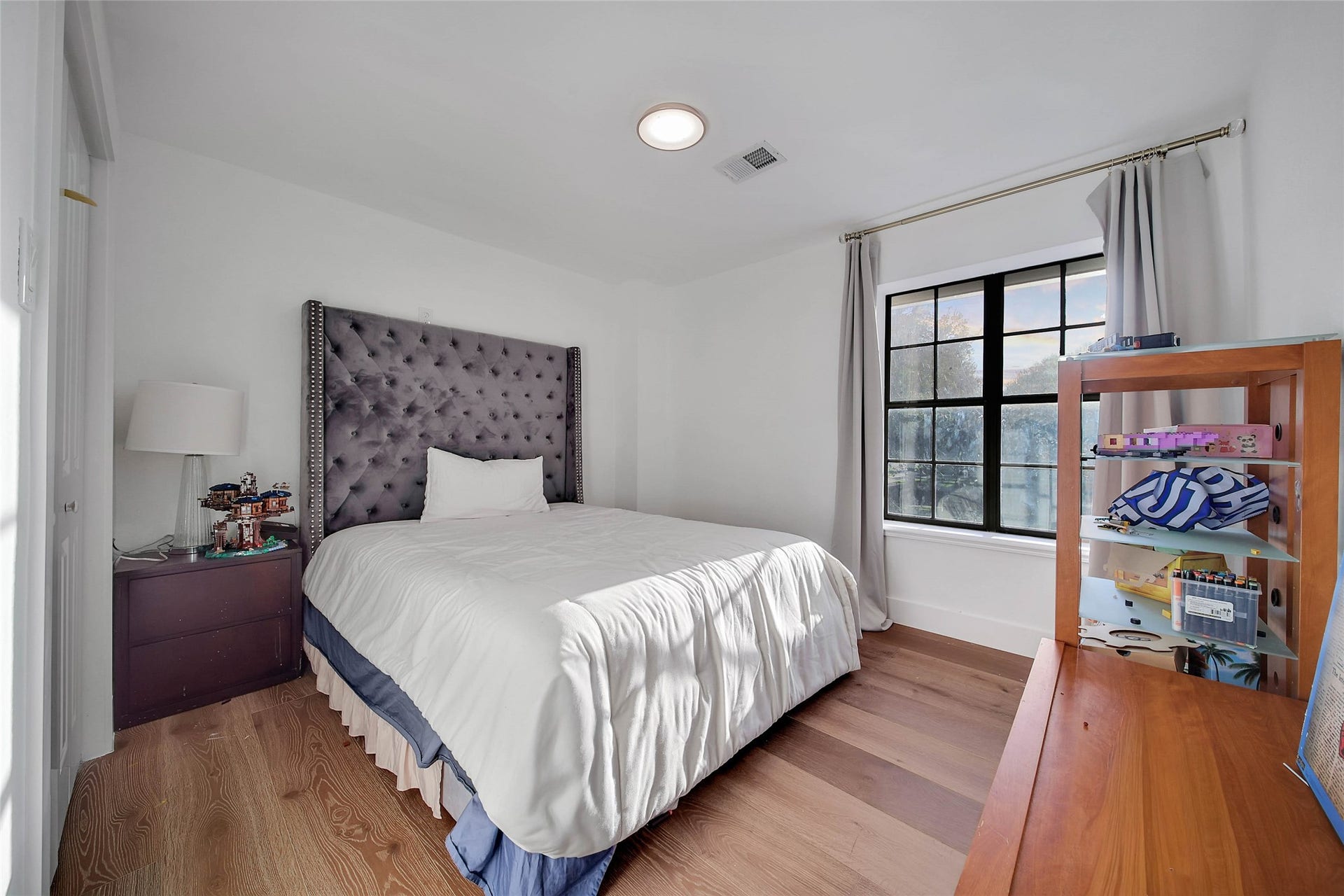 11 W Kitty Hawk ST, Richmond, TX 77406 Additional bedroom offers a comfortable layout with natural light and warm wood flooring.