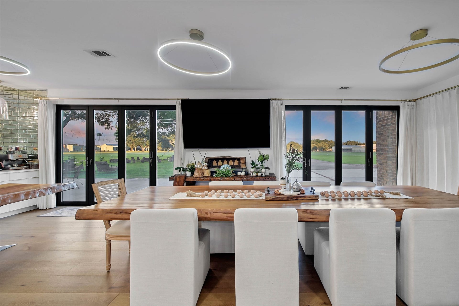 11 W Kitty Hawk ST, Richmond, TX 77406 formal Dining space positioned beside expansive custom by folding glass doors, enhancing the homes indoor-outdoor connection.