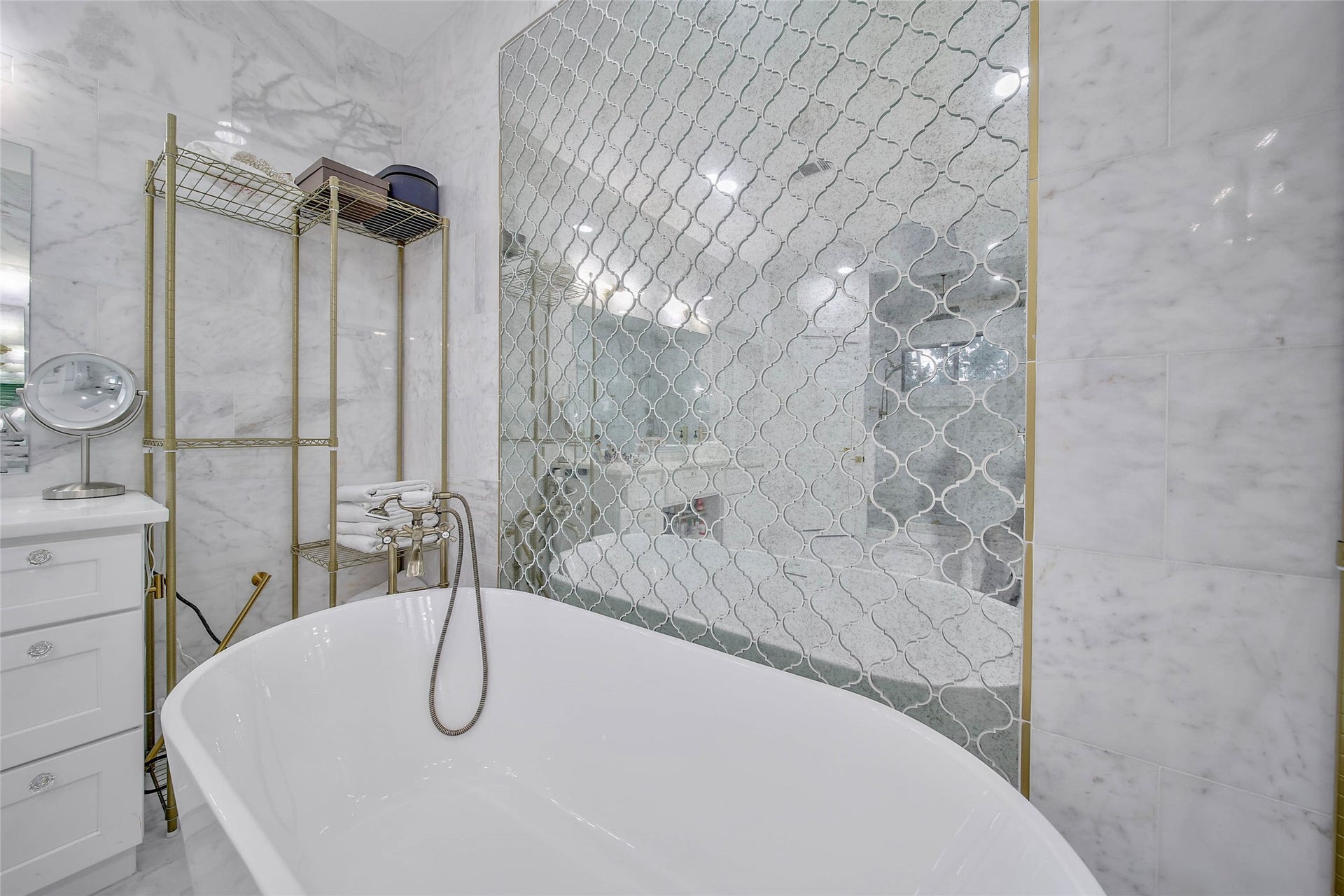 11 W Kitty Hawk ST, Richmond, TX 77406 Freestanding soaking tub and glass-enclosed shower create a relaxing, spa-like setting. floor to ceiling marble and glass mirror walls