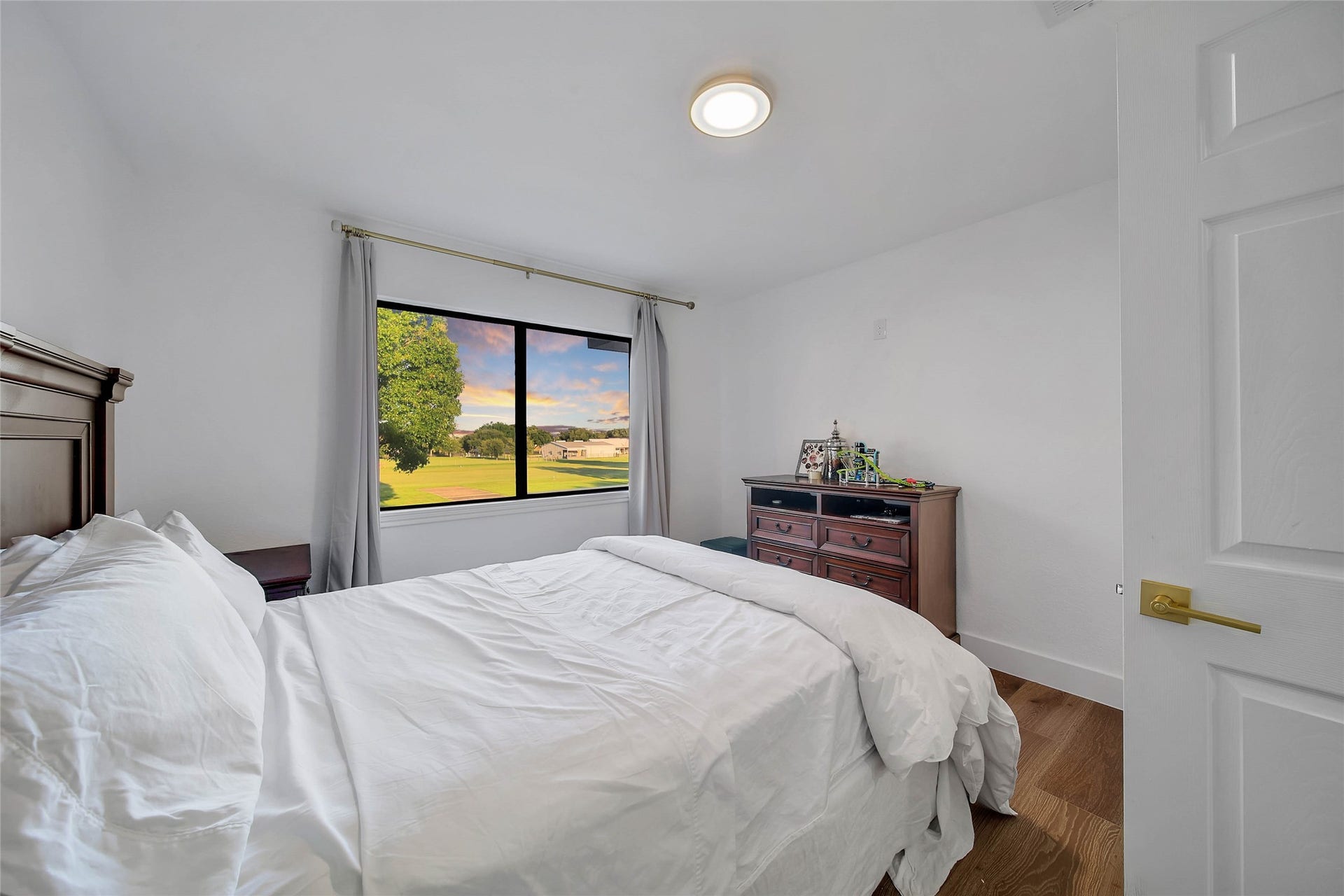 11 W Kitty Hawk ST, Richmond, TX 77406 Secondary bedroom offers natural light, wood flooring and comfortable proportions.