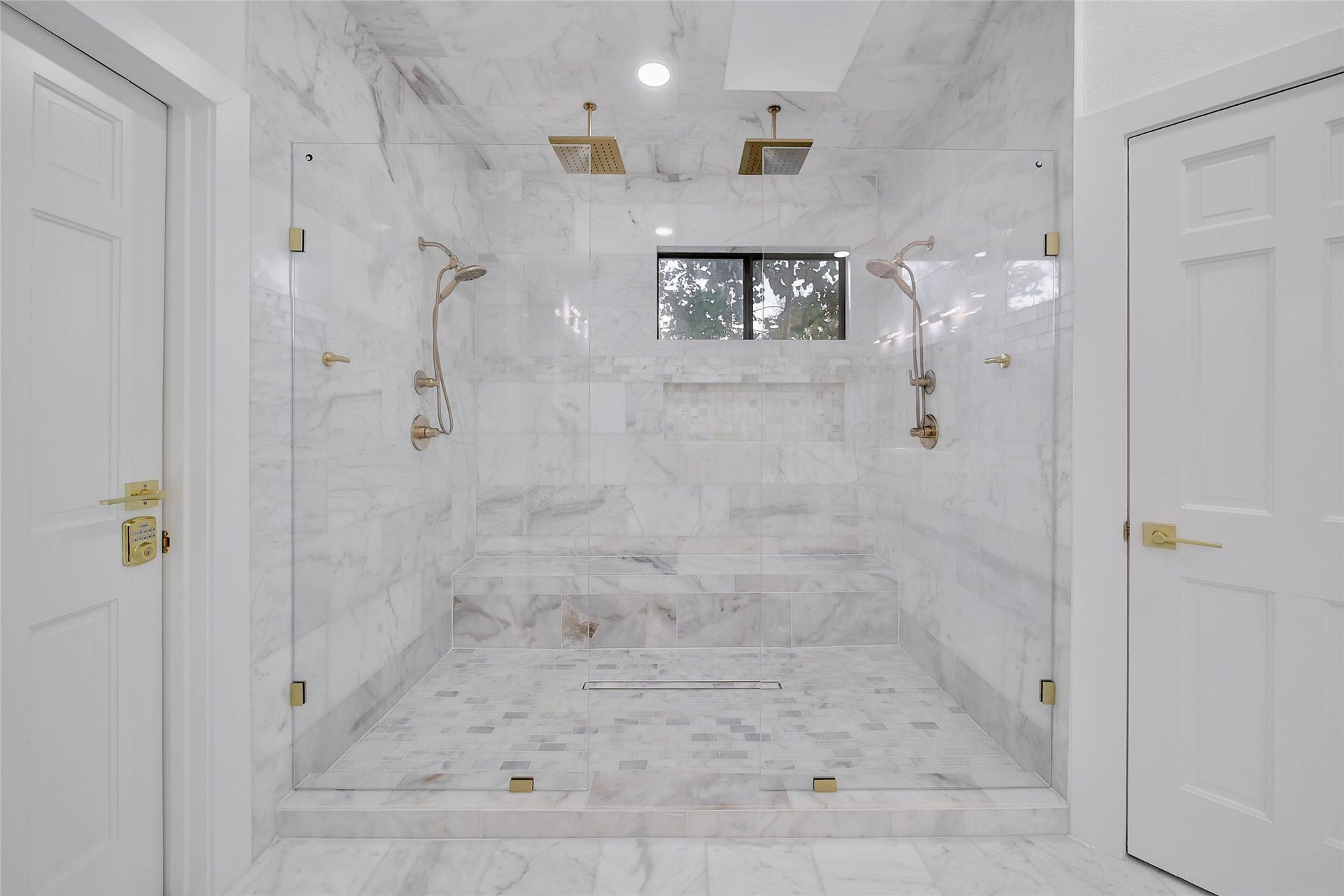 11 W Kitty Hawk ST, Richmond, TX 77406 Oversized walk-in his and her ceiling and walls shower showcases floor-to-ceiling tile marble and a clean, sophisticated design.