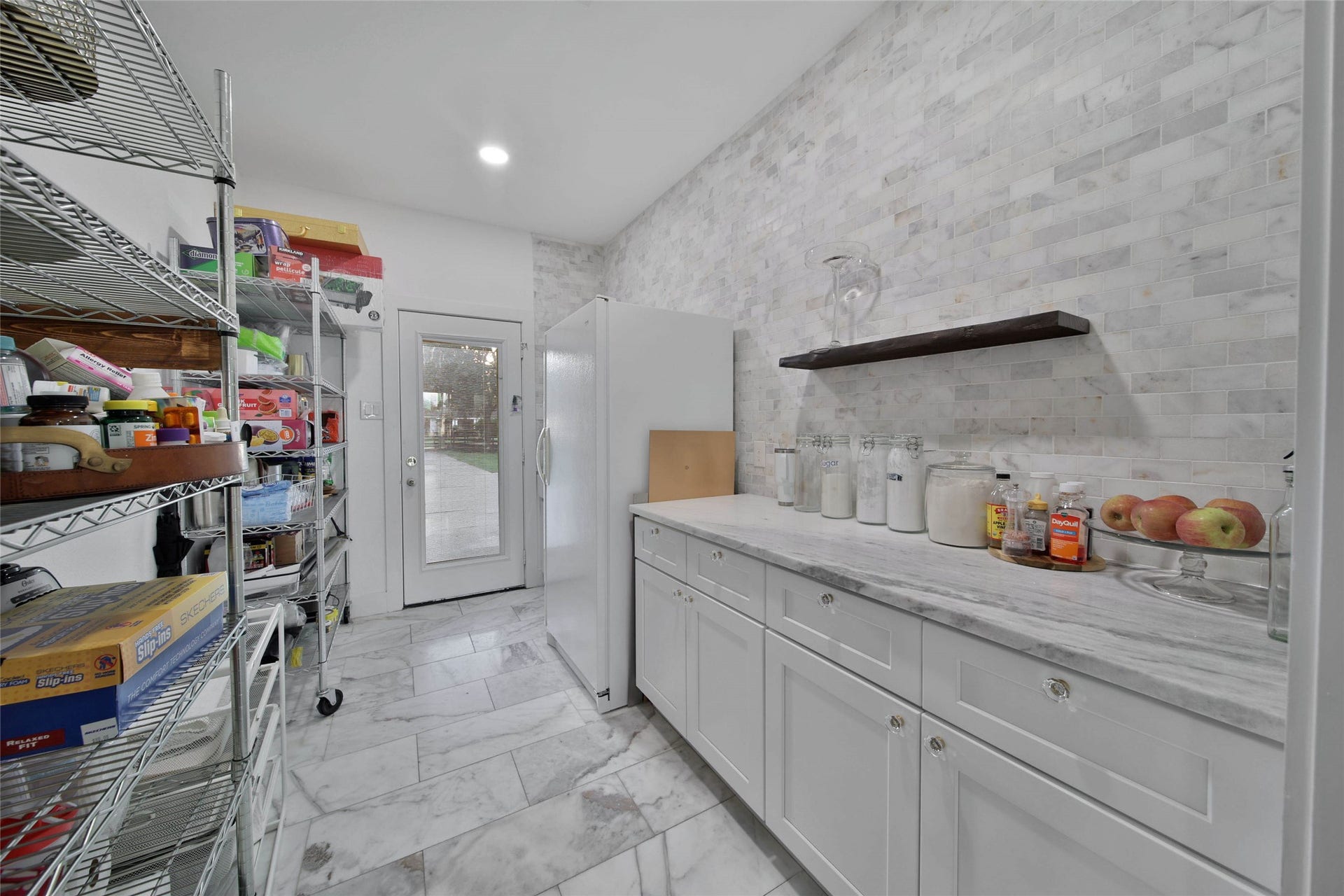 11 W Kitty Hawk ST, Richmond, TX 77406 Spacious Butlers Pantry with cabinetry, extra apron ceramic sink, countertop marble workspace, additional refrigerator space and abundant storage adjacent to the kitchen.