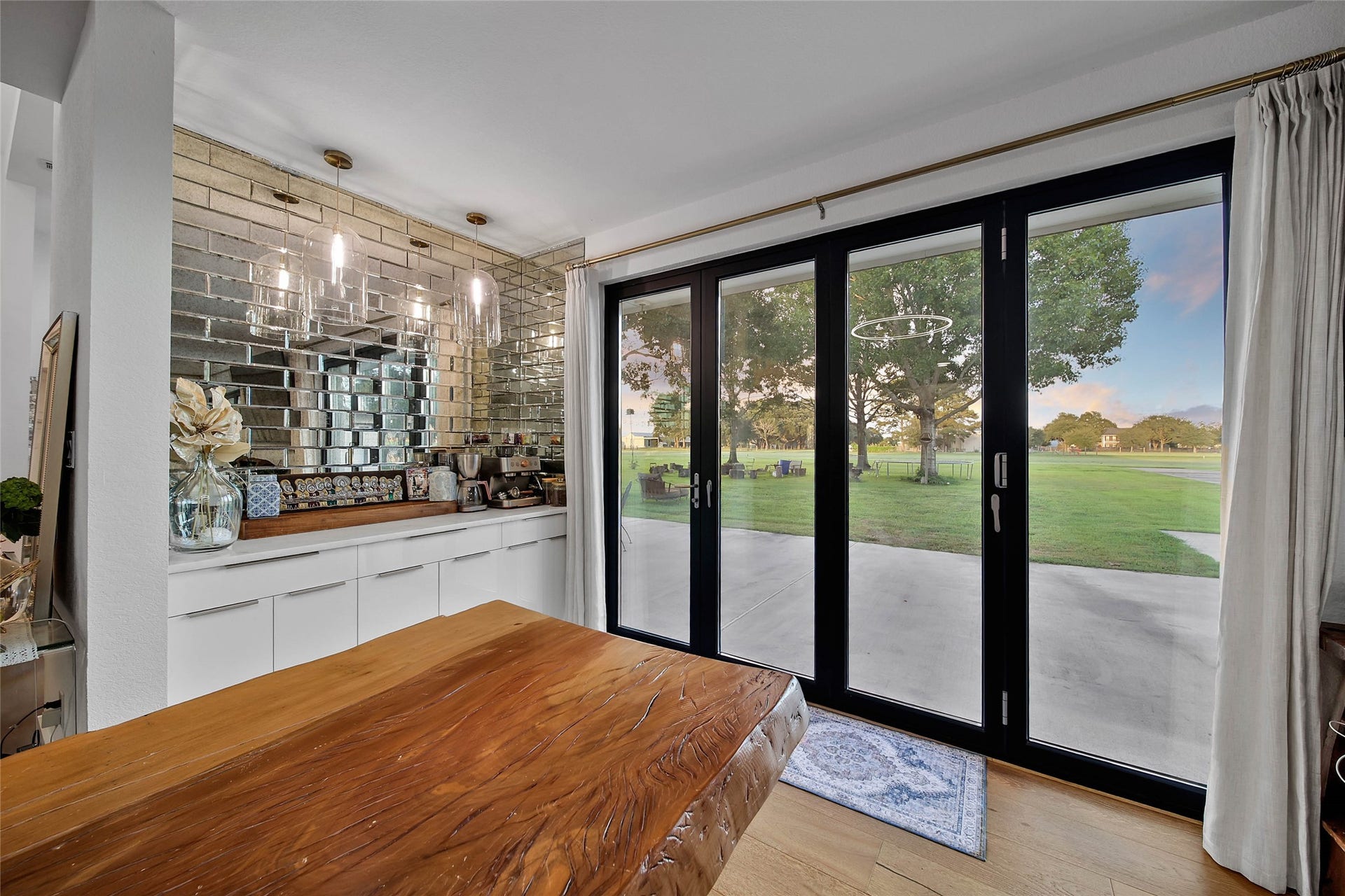 11 W Kitty Hawk ST, Richmond, TX 77406 Expansive glass-by folding door system opens the main living area toward the backyard, creating an exceptional indoor-outdoor entertaining experience.