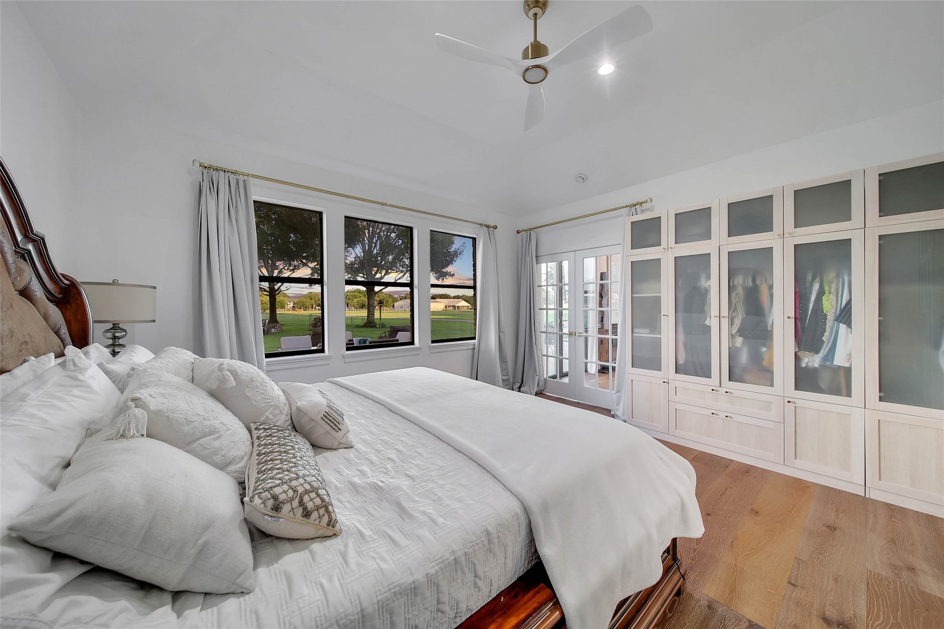 11 W Kitty Hawk ST, Richmond, TX 77406 Primary suite features multiple windows and a spacious layout with room for a substantial bedroom ensemble, double glass doors
