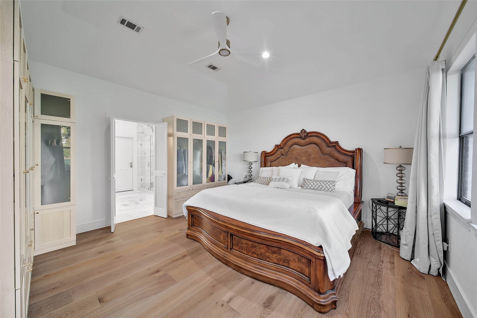 11 W Kitty Hawk ST, Richmond, TX 77406 Generously proportioned primary suite offers a private retreat with warm wood flooring and abundant natural light.