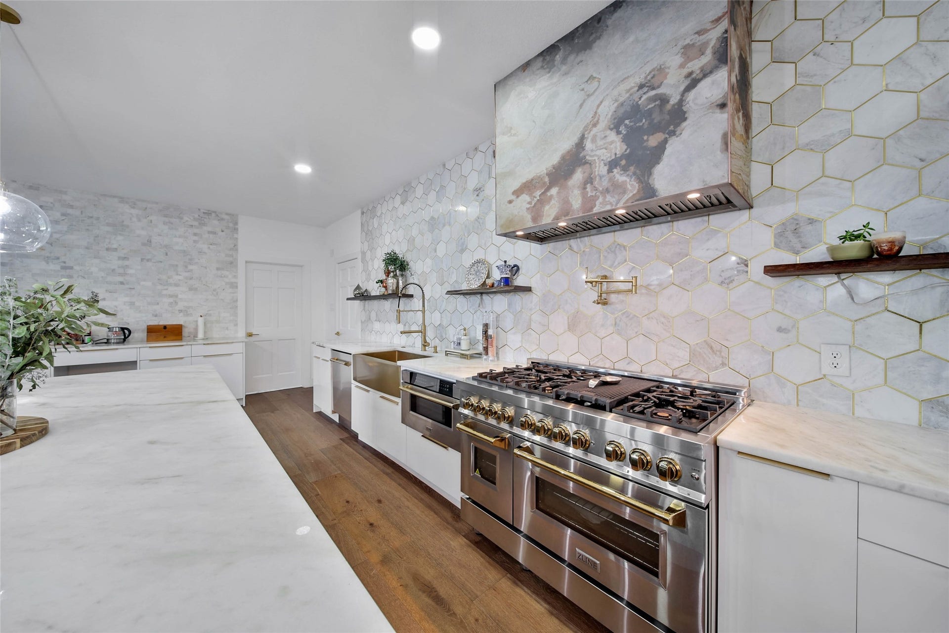 11 W Kitty Hawk ST, Richmond, TX 77406 Italian modern Chef-inspired kitchen, combines generous workspace, extensive cabinetry and a striking feature wall surrounding the cooking area, pot filler for your pasta.