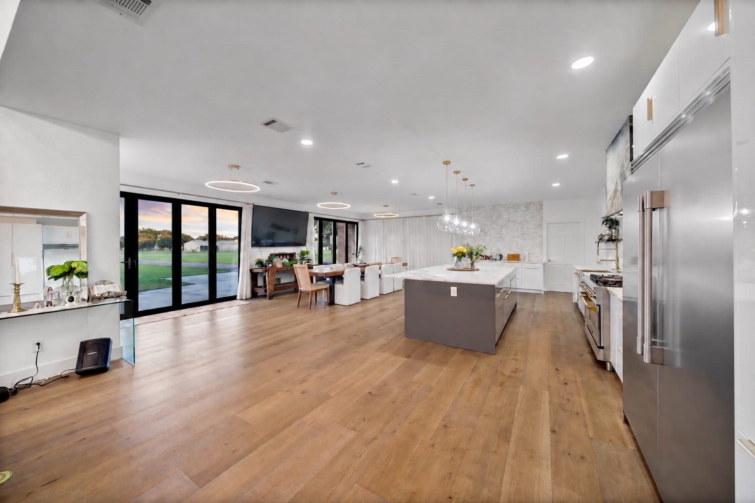 11 W Kitty Hawk ST, Richmond, TX 77406 Designed for modern living and entertaining, this expansive open-concept space combines a sophisticated kitchen, dining and living areas with direct views of the airpark.