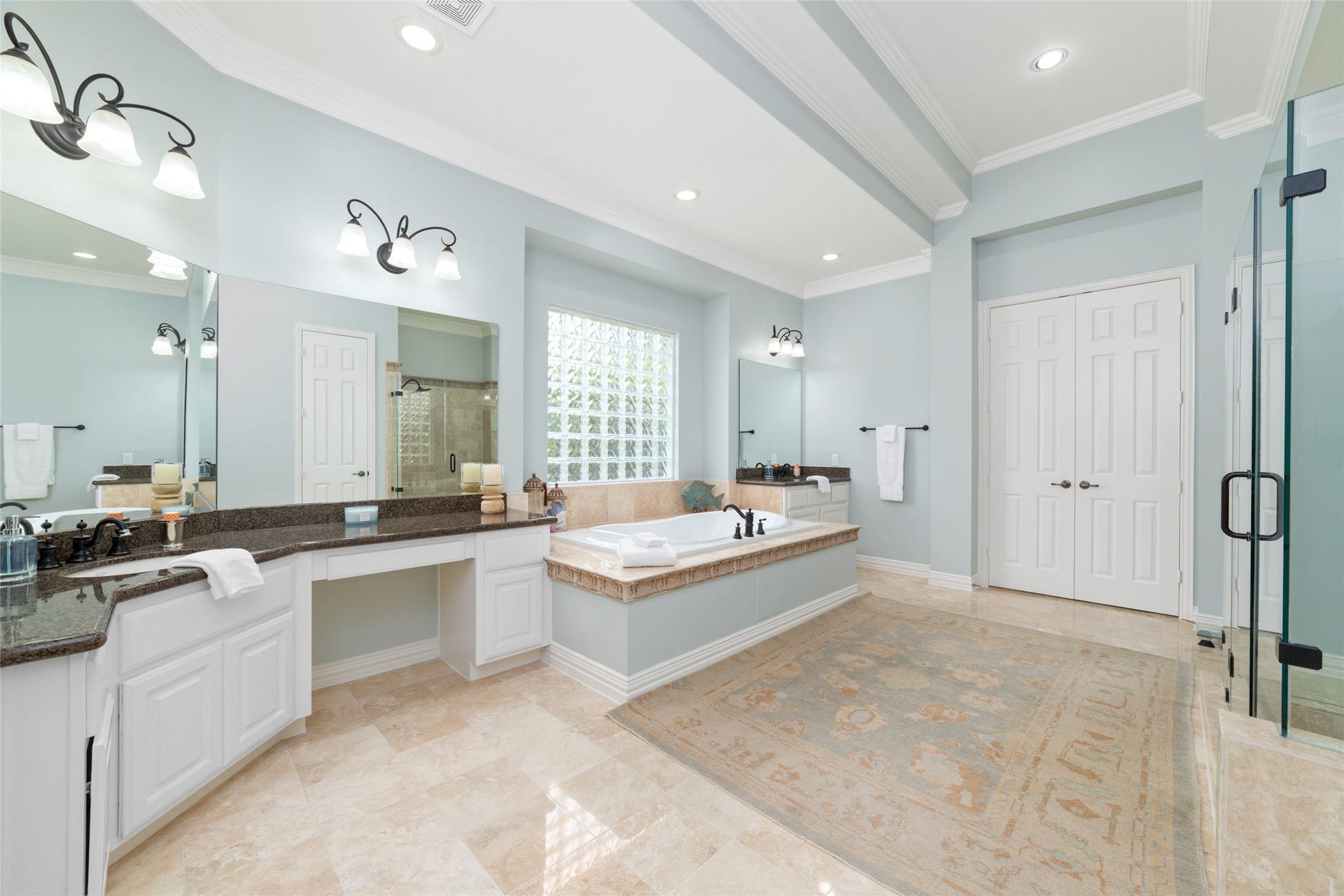 Double vanities separated by jacuzzi tub