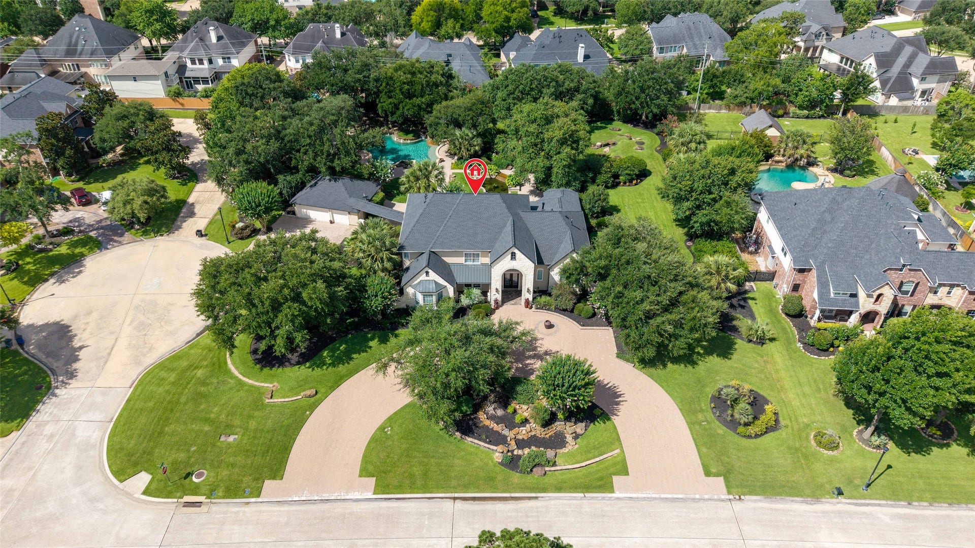 Aerial view showcases the large circular driveway.