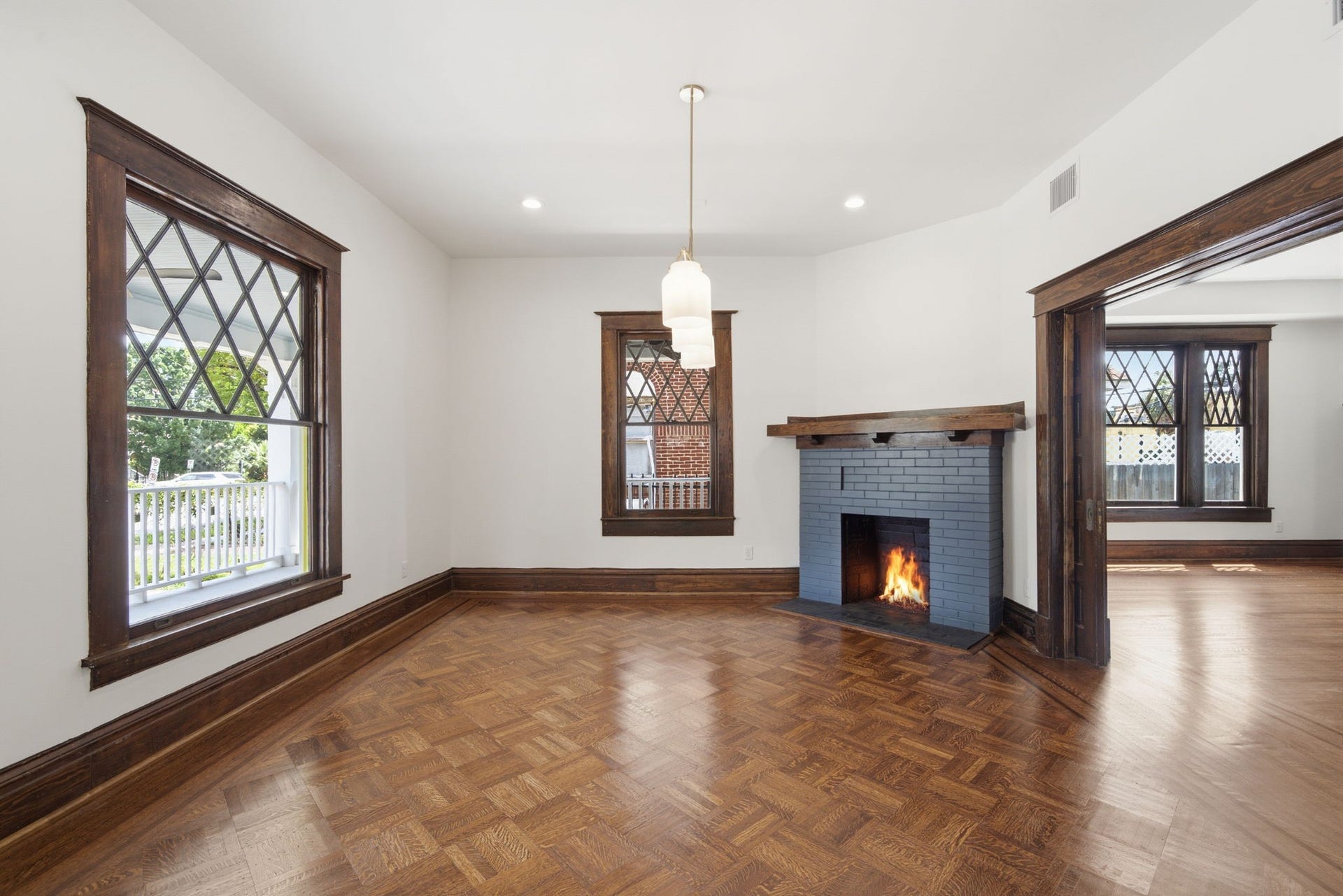 404 Avondale Street, Houston, TX 77006 Charming dining area featuring a cozy fireplace, rich wood trim, and elegant diamond-patterned windows, creating a warm and inviting atmosphere.