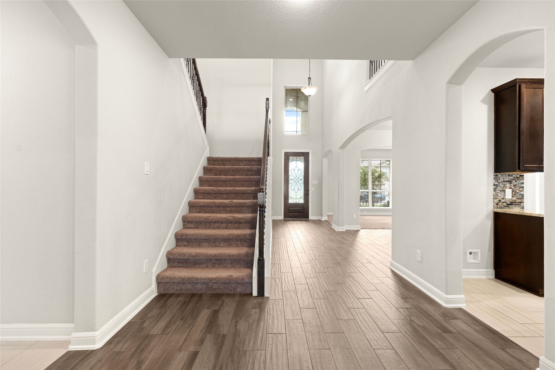 3015 Dawn Light Drive, Rosenberg, TX 77471 Elegant staircase with wrought-iron railing