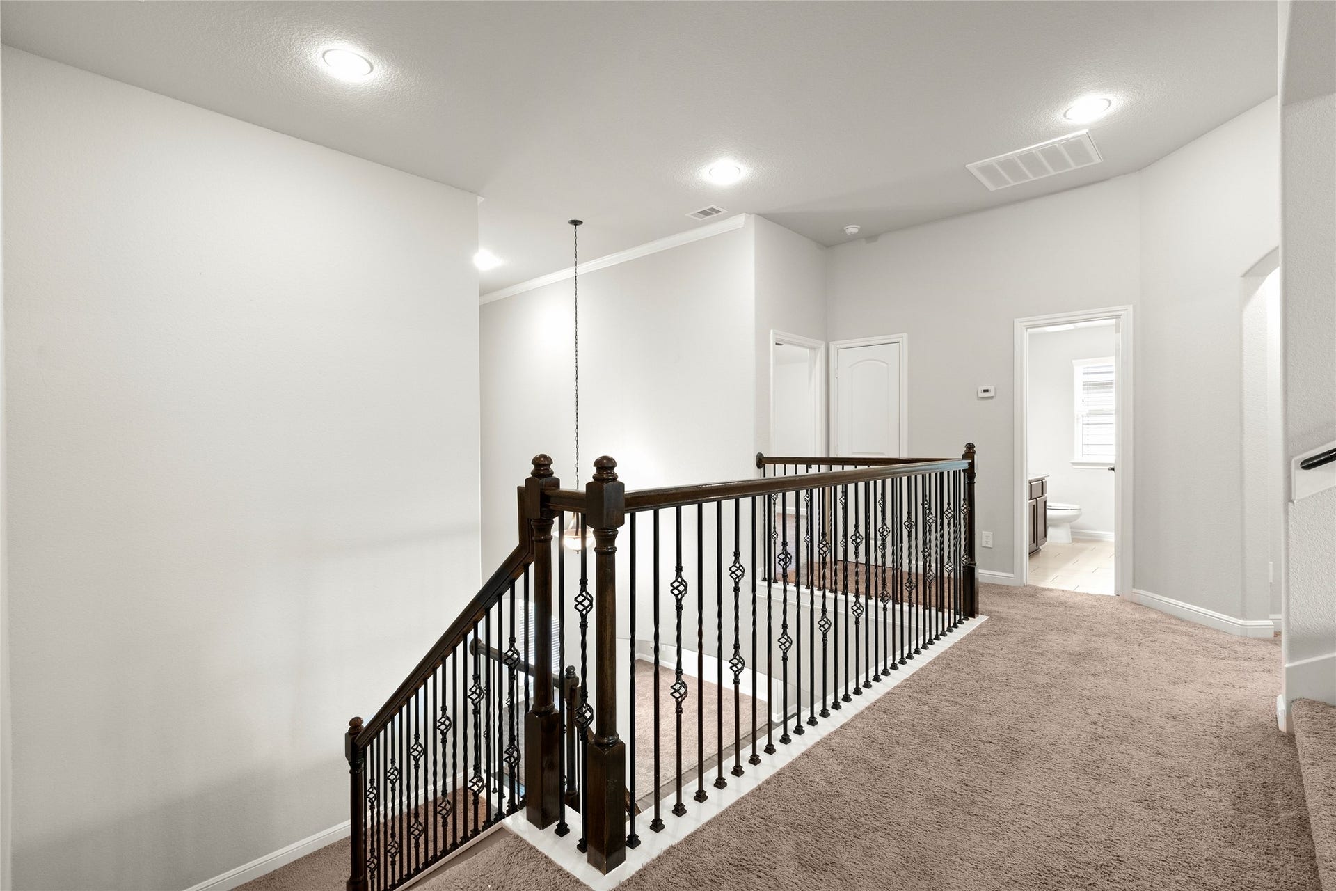 3015 Dawn Light Drive, Rosenberg, TX 77471 Upstairs landing with wrought-iron railing