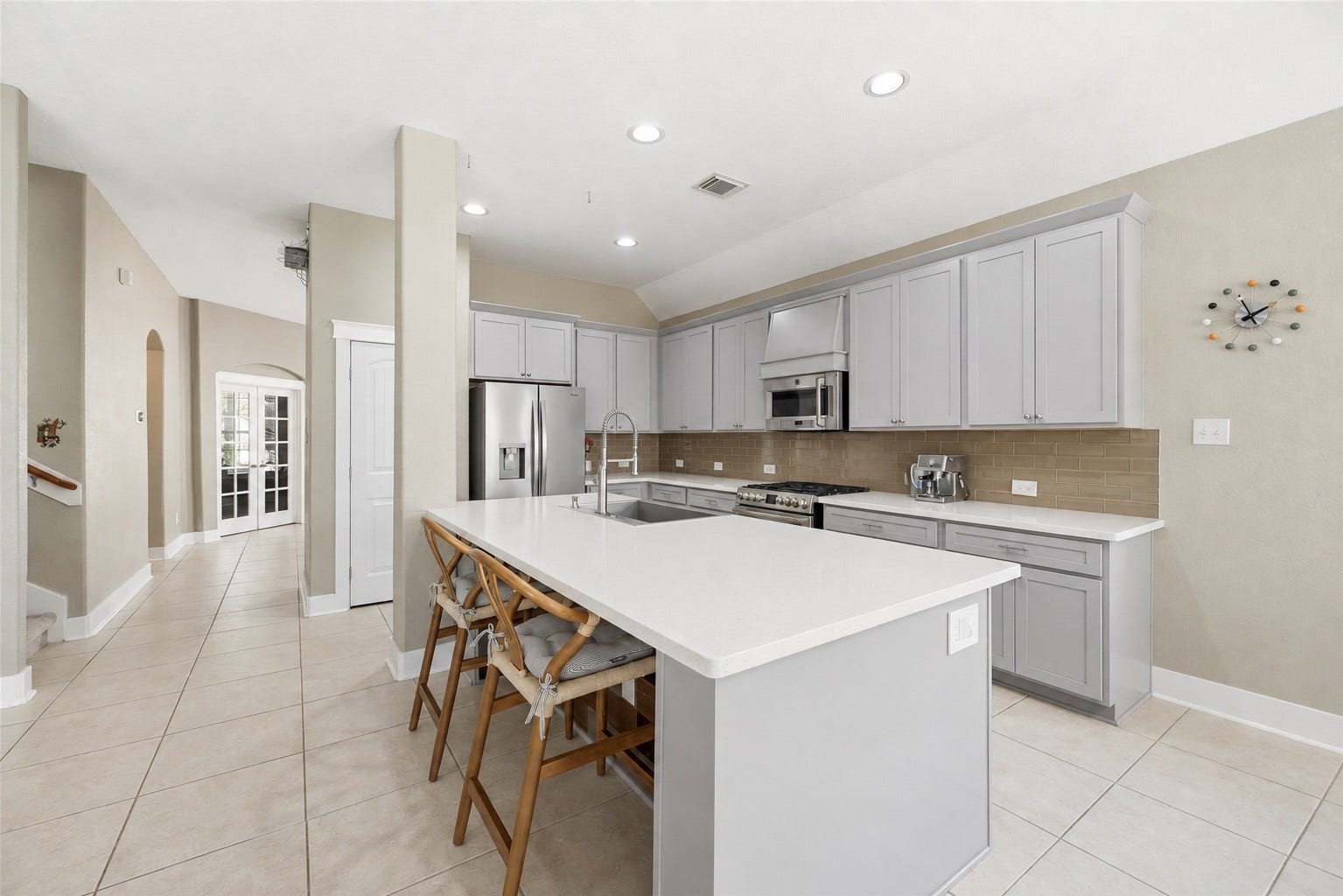 20918 Field Manor Lane, Katy, TX 77450 Generous island seating and an open view of the living room.