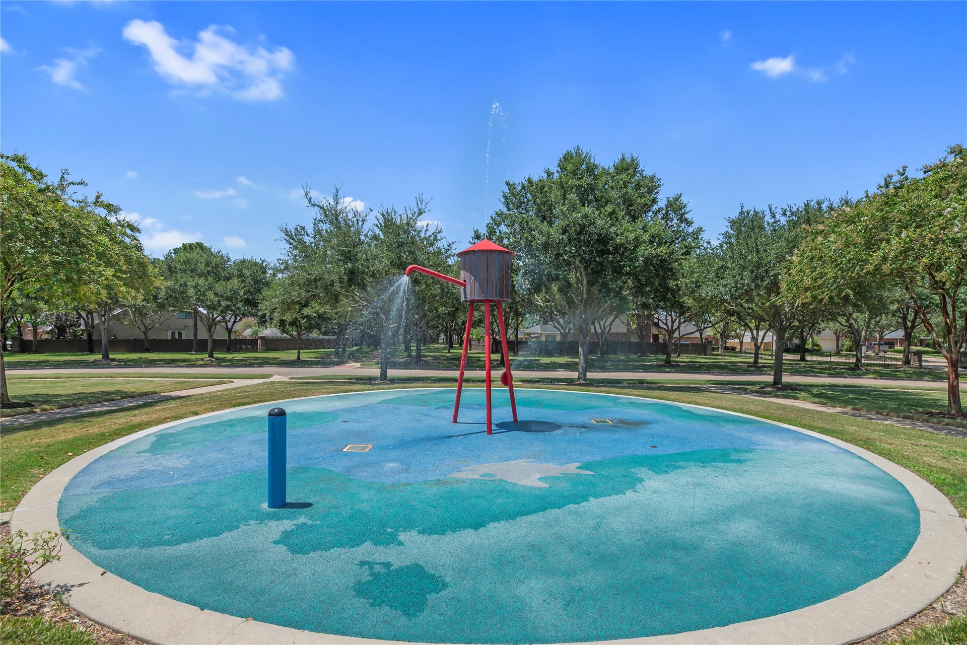 20918 Field Manor Lane, Katy, TX 77450 one of many community splash pads with playful water features, surrounded by lush greenery, perfect for family fun and relaxation.