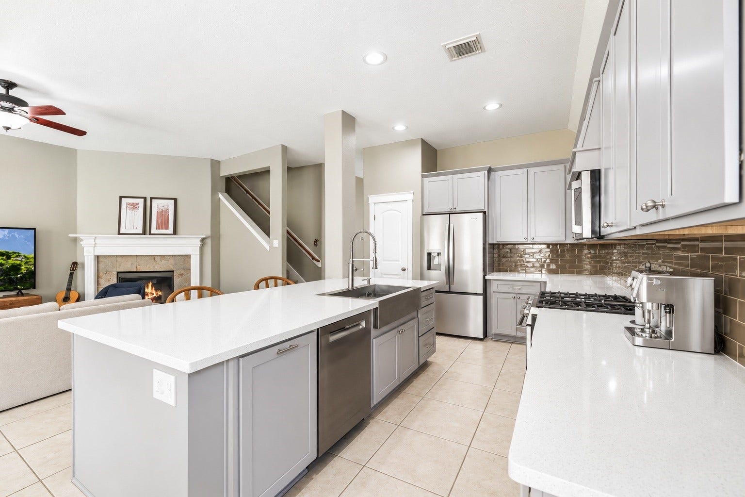 20918 Field Manor Lane, Katy, TX 77450 Modern kitchen featuring sleek gray cabinetry, stainless steel appliances, and a spacious island with a farmhouse sink.