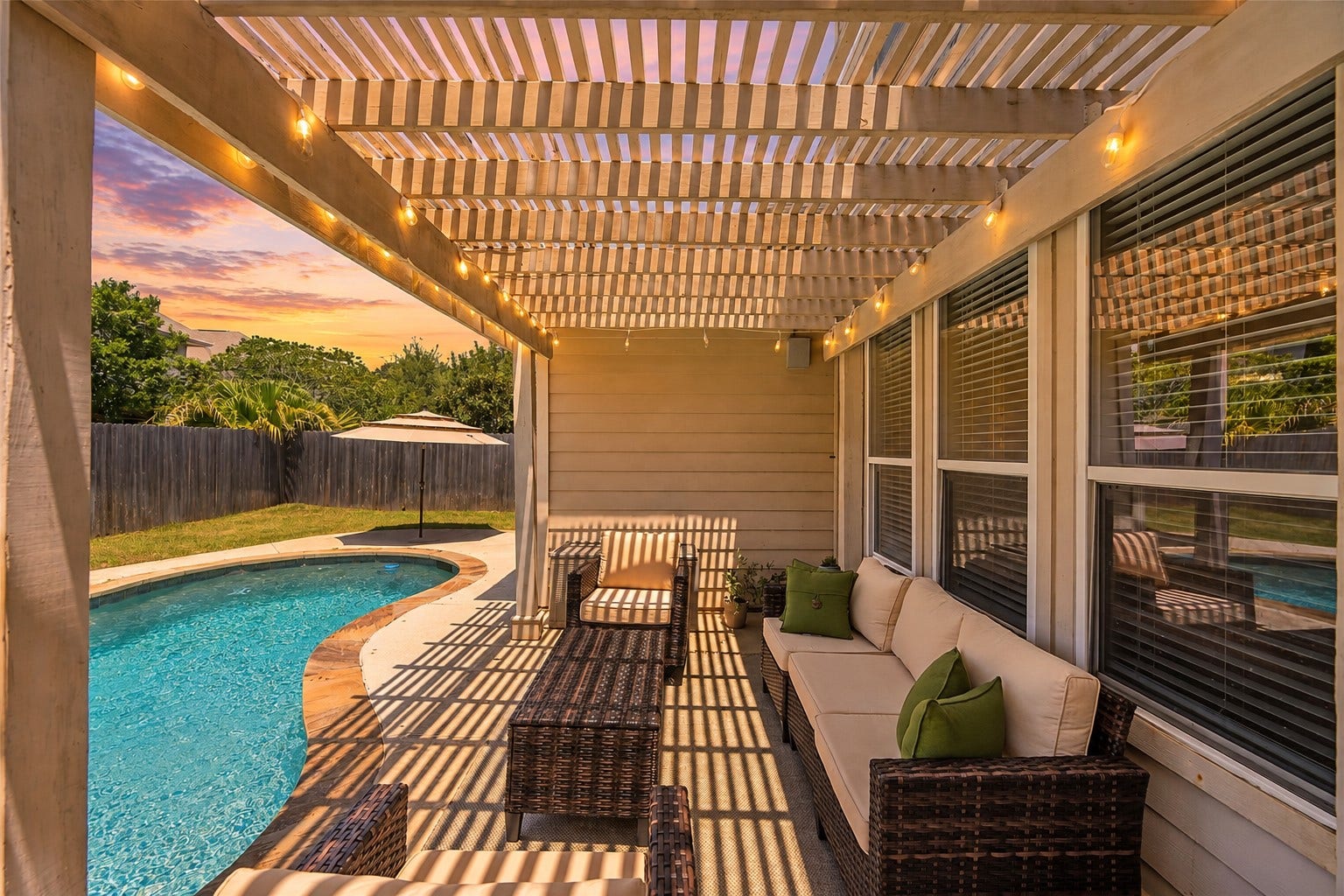 20918 Field Manor Lane, Katy, TX 77450 Experience serene evenings by the inviting pool, accented with cascading water features and ambient lighting, under a pergola with a cozy seating area.