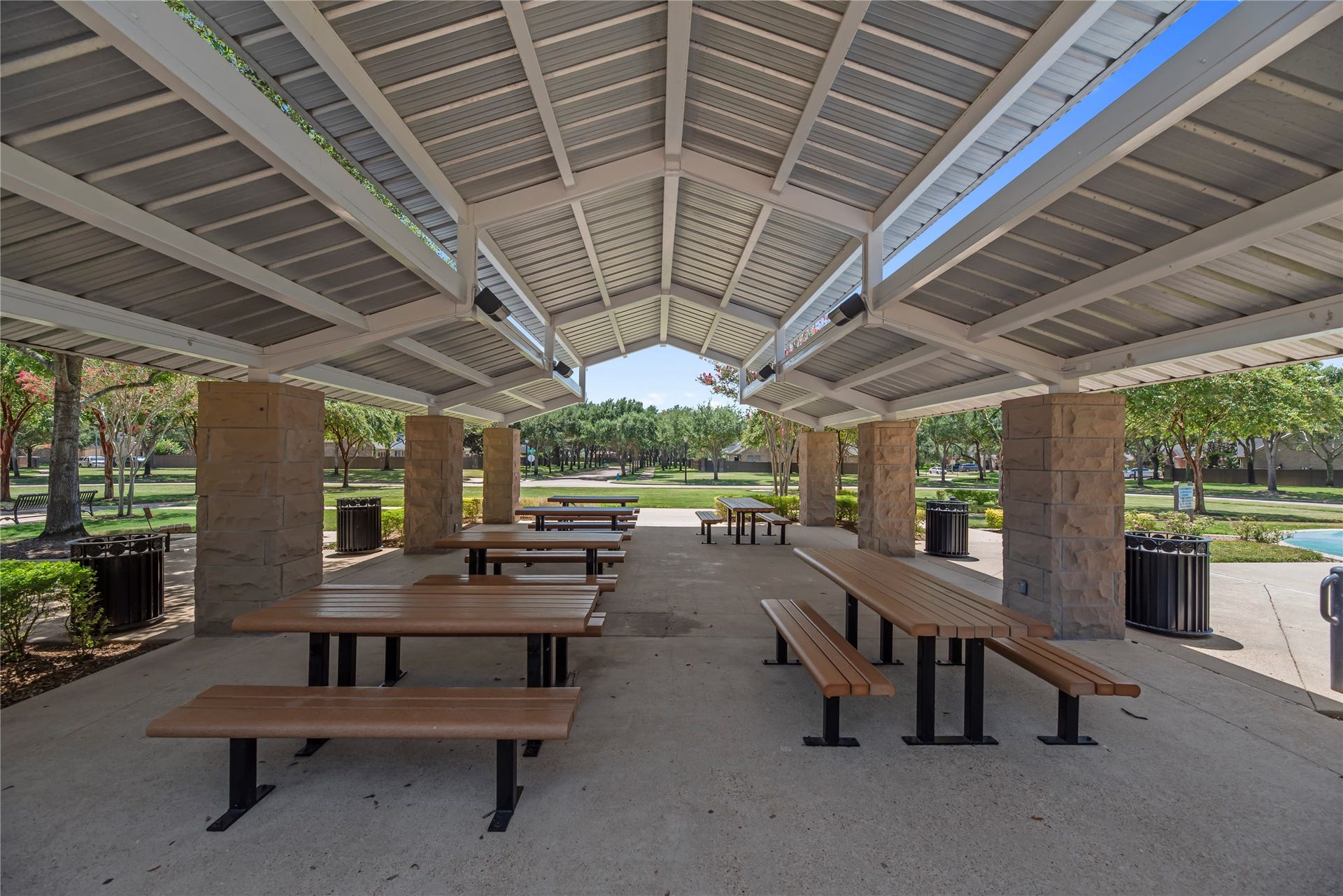 20918 Field Manor Lane, Katy, TX 77450 Spacious covered picnic area with ample seating, surrounded by lush greenery and a serene park setting, perfect for outdoor gatherings and relaxation.