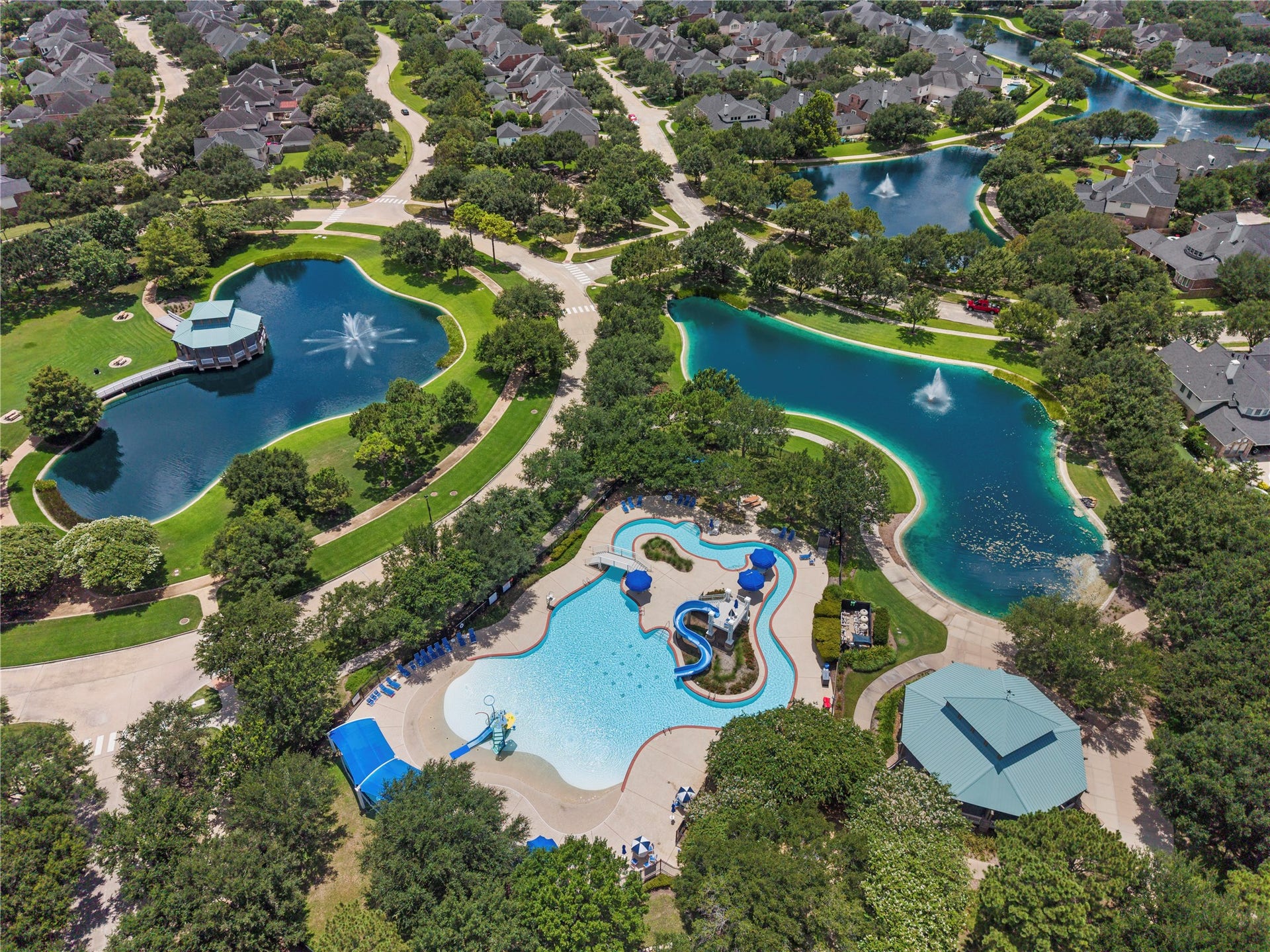 20918 Field Manor Lane, Katy, TX 77450 Experience vibrant community living with scenic ponds, walking paths, and a resort-style pool featuring water slides and lush landscaping.