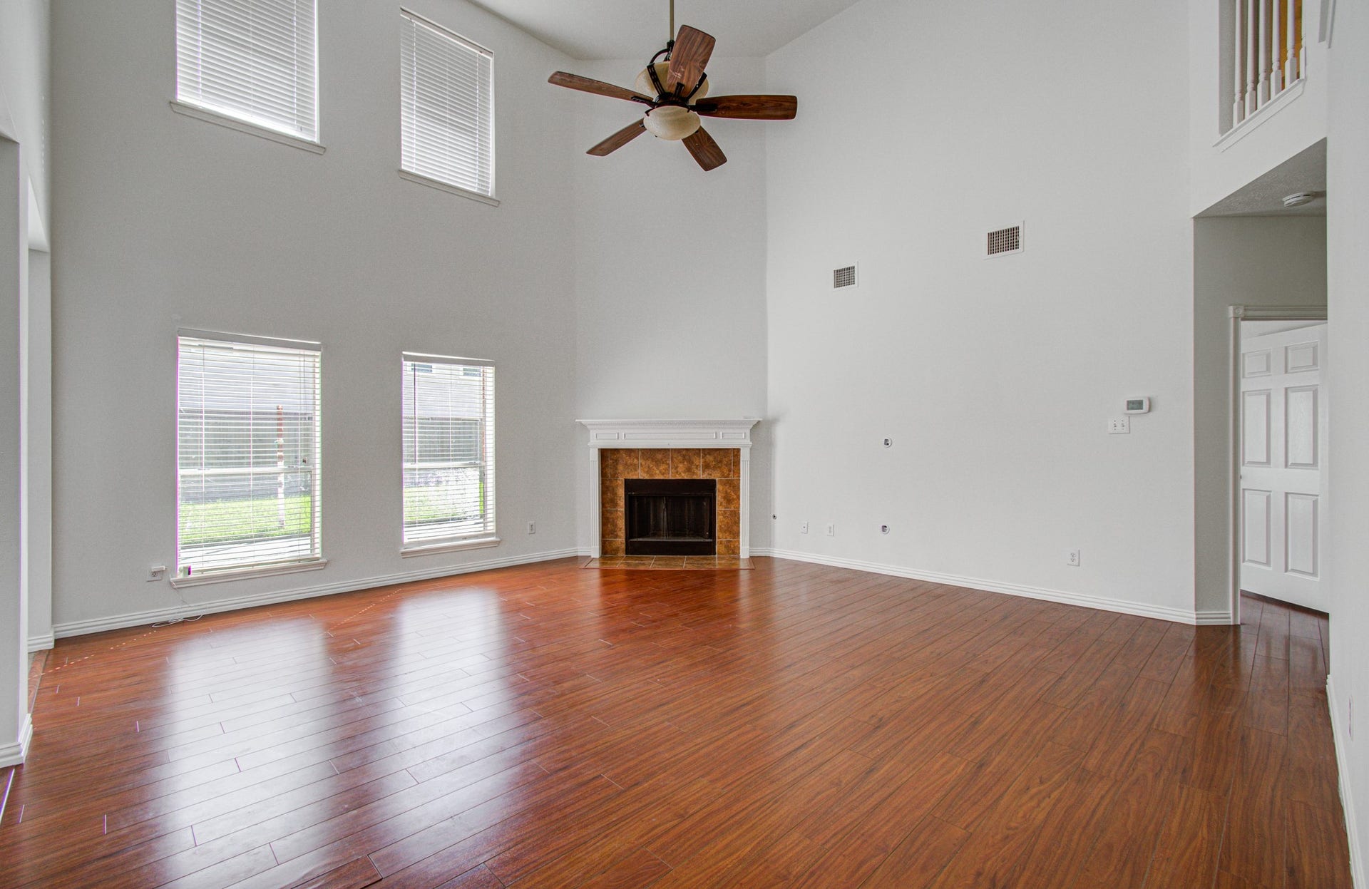 1402 Pine Knot Court, Pearland, TX 77581 The family room has wood like laminate flooring and a gas log fireplace.