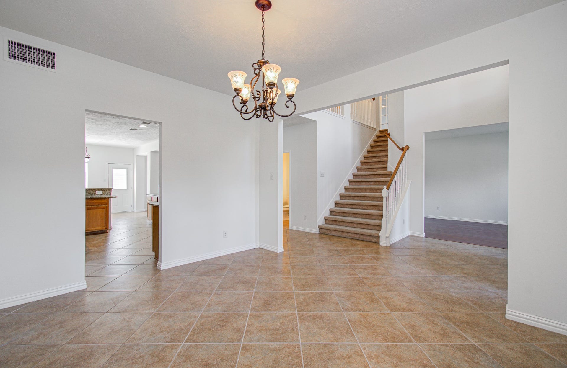 1402 Pine Knot Court, Pearland, TX 77581 Open formal dining. The kitchen entry is on the left.