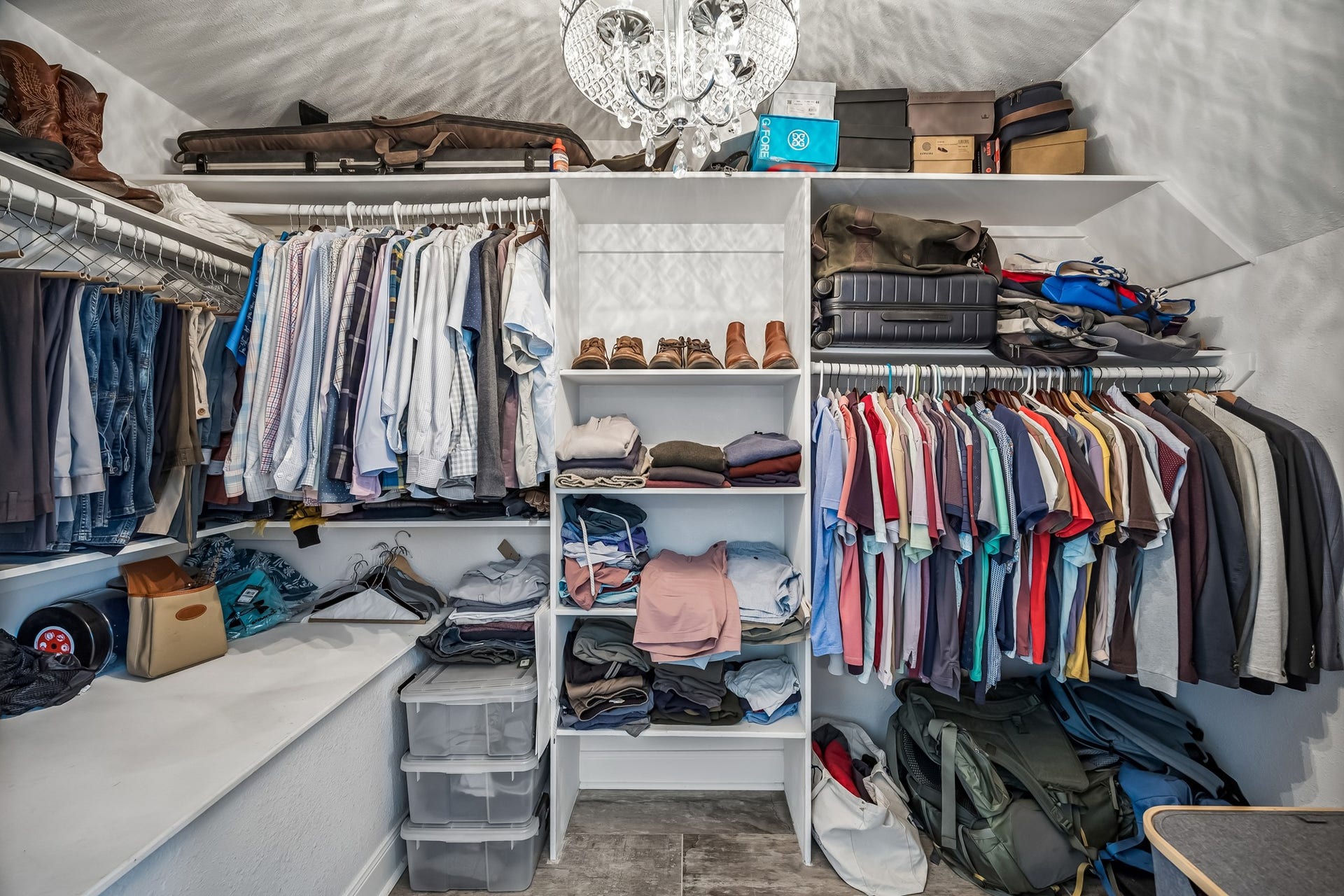 14719 Barryknoll Lane, #51, Houston, TX 77079 The primary closet offers abundant hanging space, built-in shelving, and room for seasonal storage. A chandelier adds a polished touch while keeping the space bright and easy to navigate.