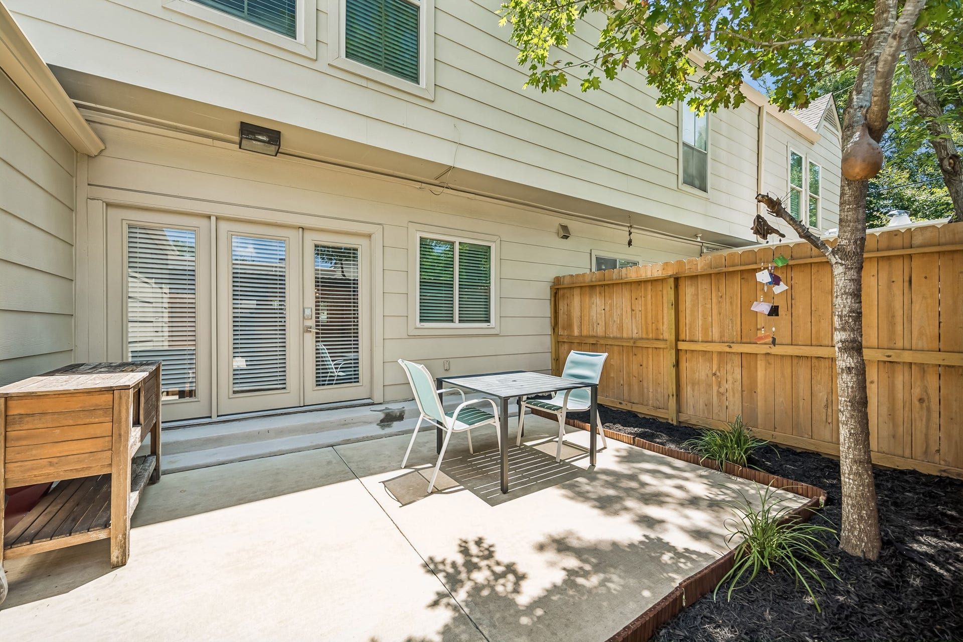 14719 Barryknoll Lane, #51, Houston, TX 77079 The private outdoor patio provides room for seating, grilling, or container gardening, with fencing and mature trees adding shade and privacy.