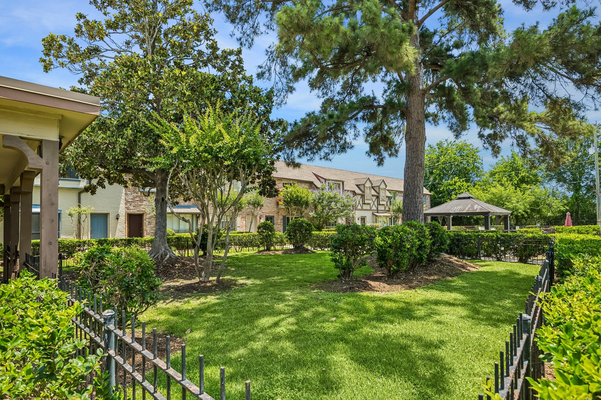 14719 Barryknoll Lane, #51, Houston, TX 77079 Mature trees and manicured green space frame the front approach, creating a welcoming first impression for this Barryknoll townhome.