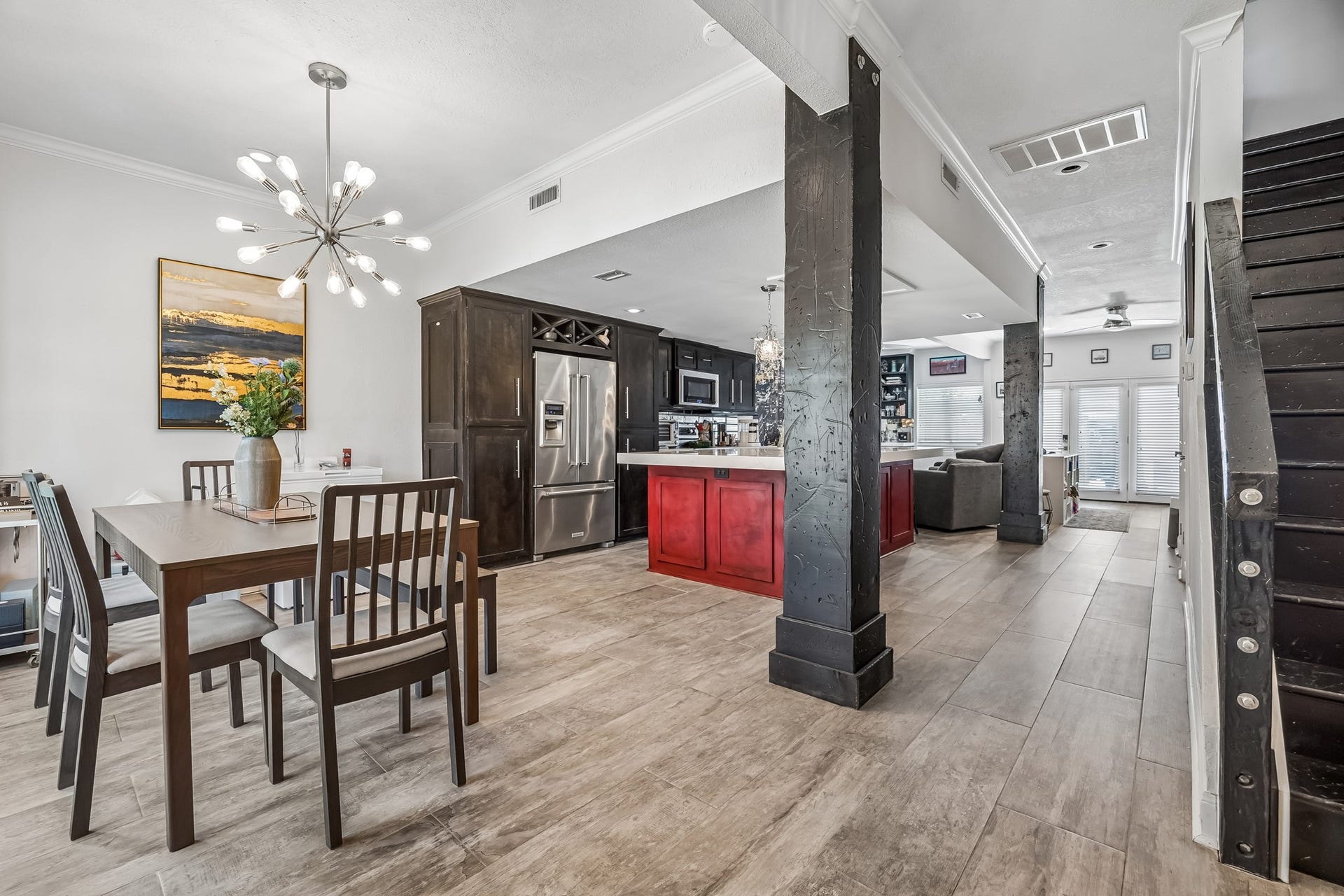 14719 Barryknoll Lane, #51, Houston, TX 77079 The dining area connects seamlessly to the kitchen and living room, creating an easy flow for daily living and entertaining. Wood-look flooring, crown molding, and modern lighting add a polished finish throughout the main level.