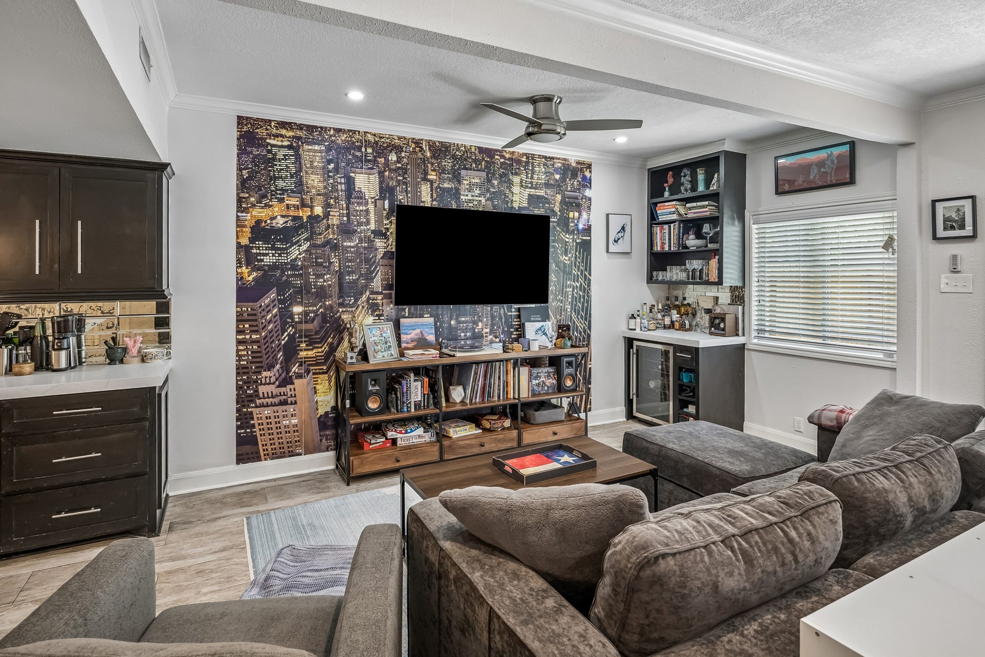 14719 Barryknoll Lane, #51, Houston, TX 77079 The living area offers a comfortable gathering space with tile flooring, neutral finishes, and a stone fireplace that adds warmth and character. Large openings help the room feel connected and easy to furnish.