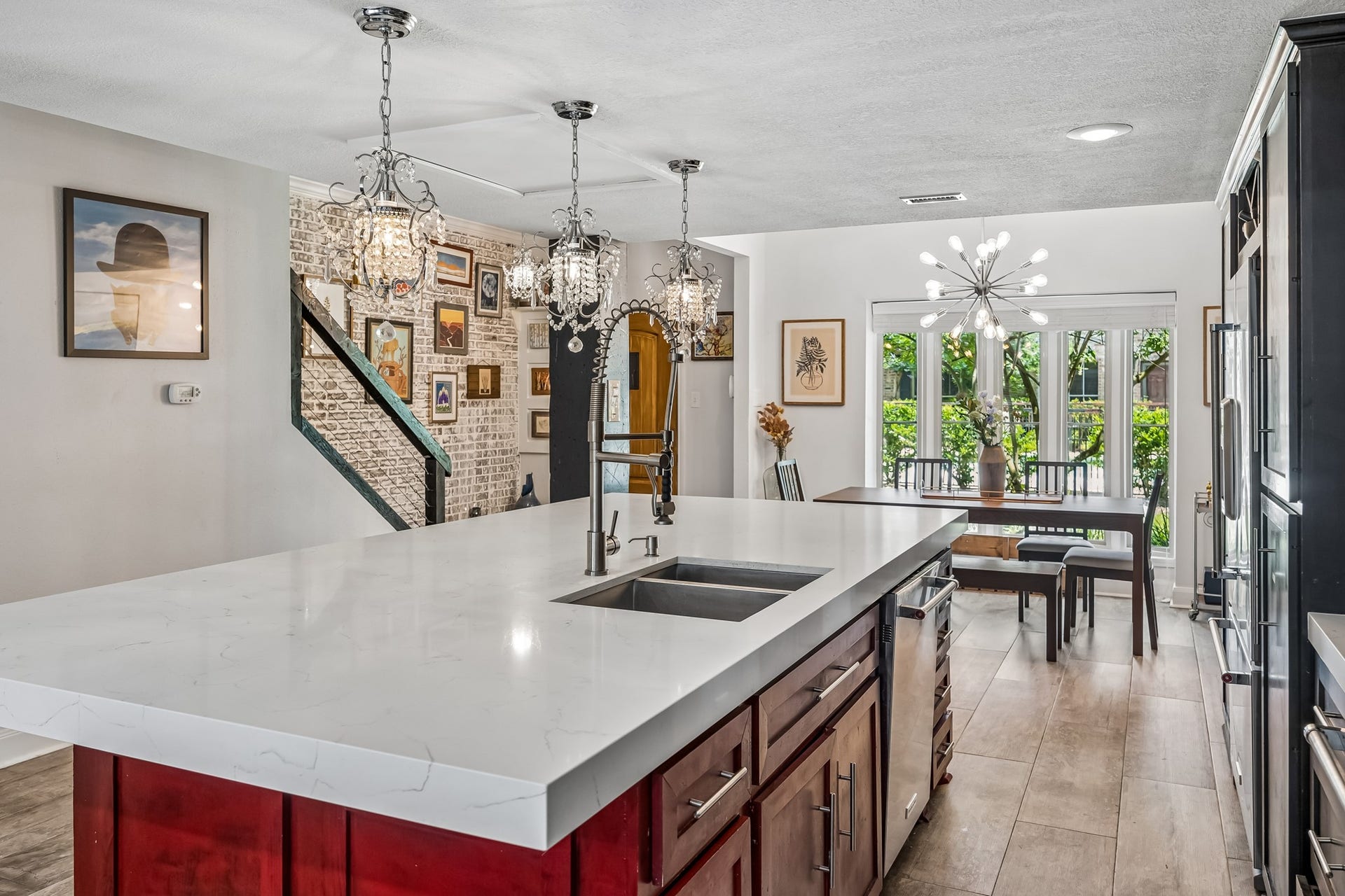 14719 Barryknoll Lane, #51, Houston, TX 77079 The oversized island provides abundant workspace, a deep sink, and additional storage while keeping the kitchen open to the dining area. Decorative pendant lighting and the large front-facing window add brightness and style to this central gathering space.