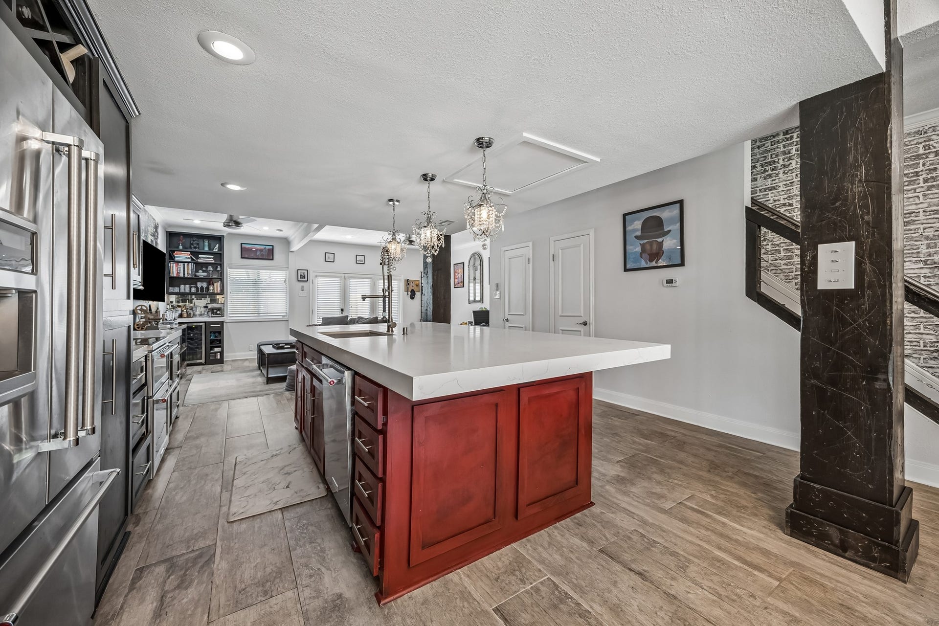14719 Barryknoll Lane, #51, Houston, TX 77079 This kitchen view highlights the generous island storage, wide work surface, and open sightline into the family room. Recessed lighting, pendant fixtures, and continuous flooring keep the space bright, connected, and highly functional.