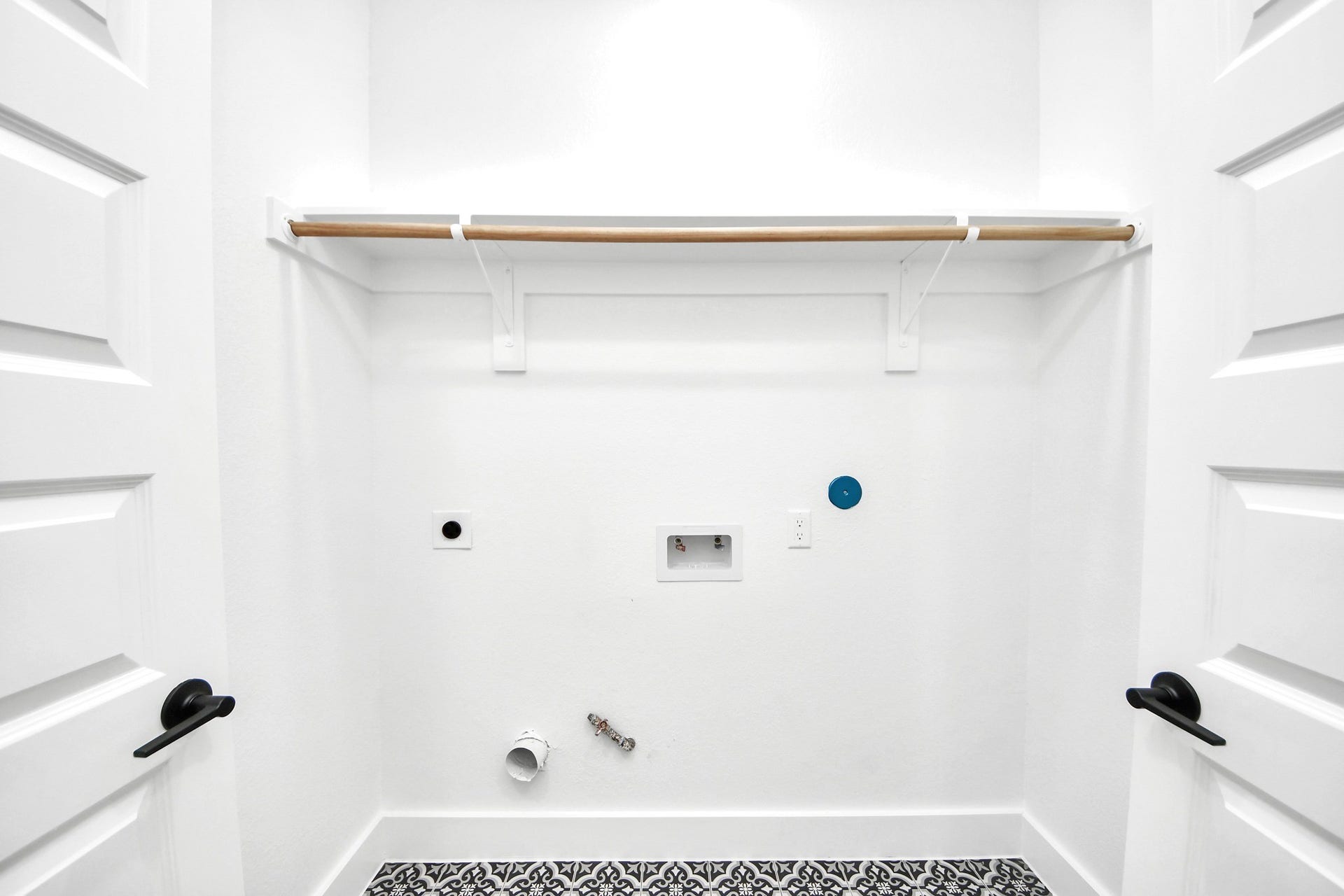 Unit Ds dedicated laundry area keeps household essentials accessible, efficient and neatly contained.