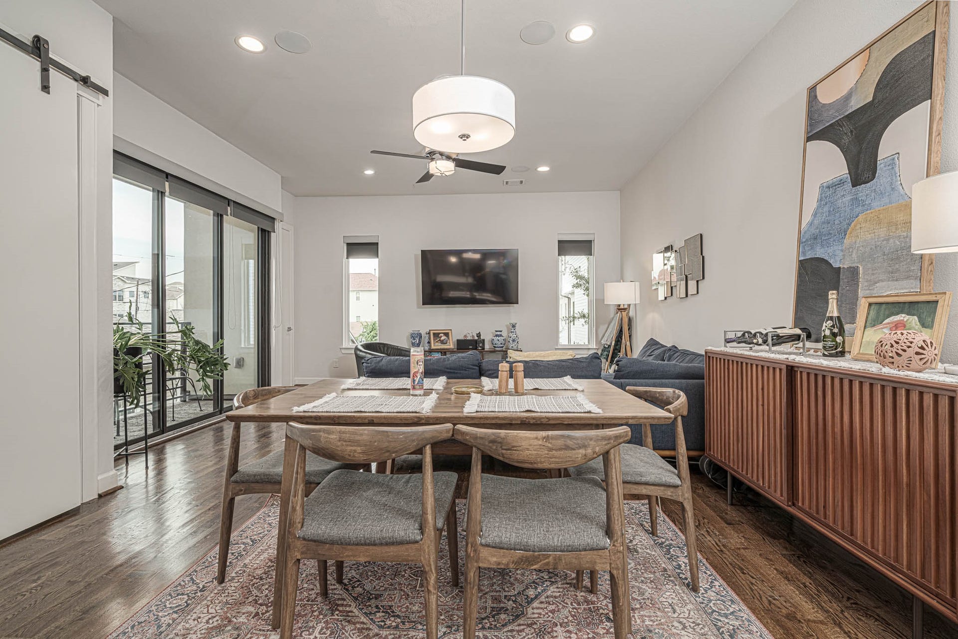 1615 Bingham Street, Houston, TX 77007 Elevate your lifestyle in this stylish second-floor living space, featuring an open concept with elegant dining, a cozy seating area, and abundant natural light from expansive sliding doors.