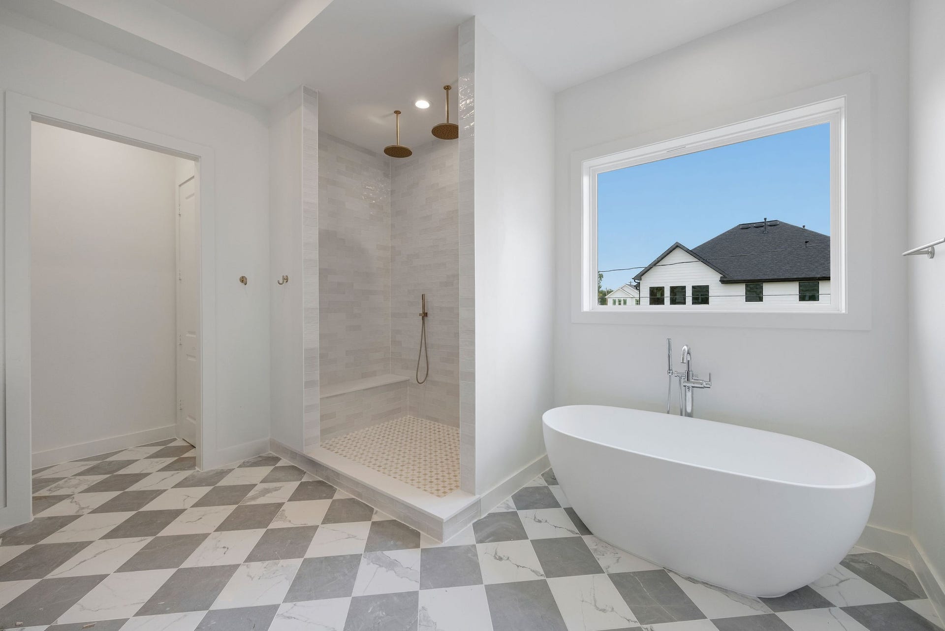 1726 Saxon Drive, Houston, TX 77018 The elegant primary bathroom offers a large shower, soaking tub, double sinks, and private WC.