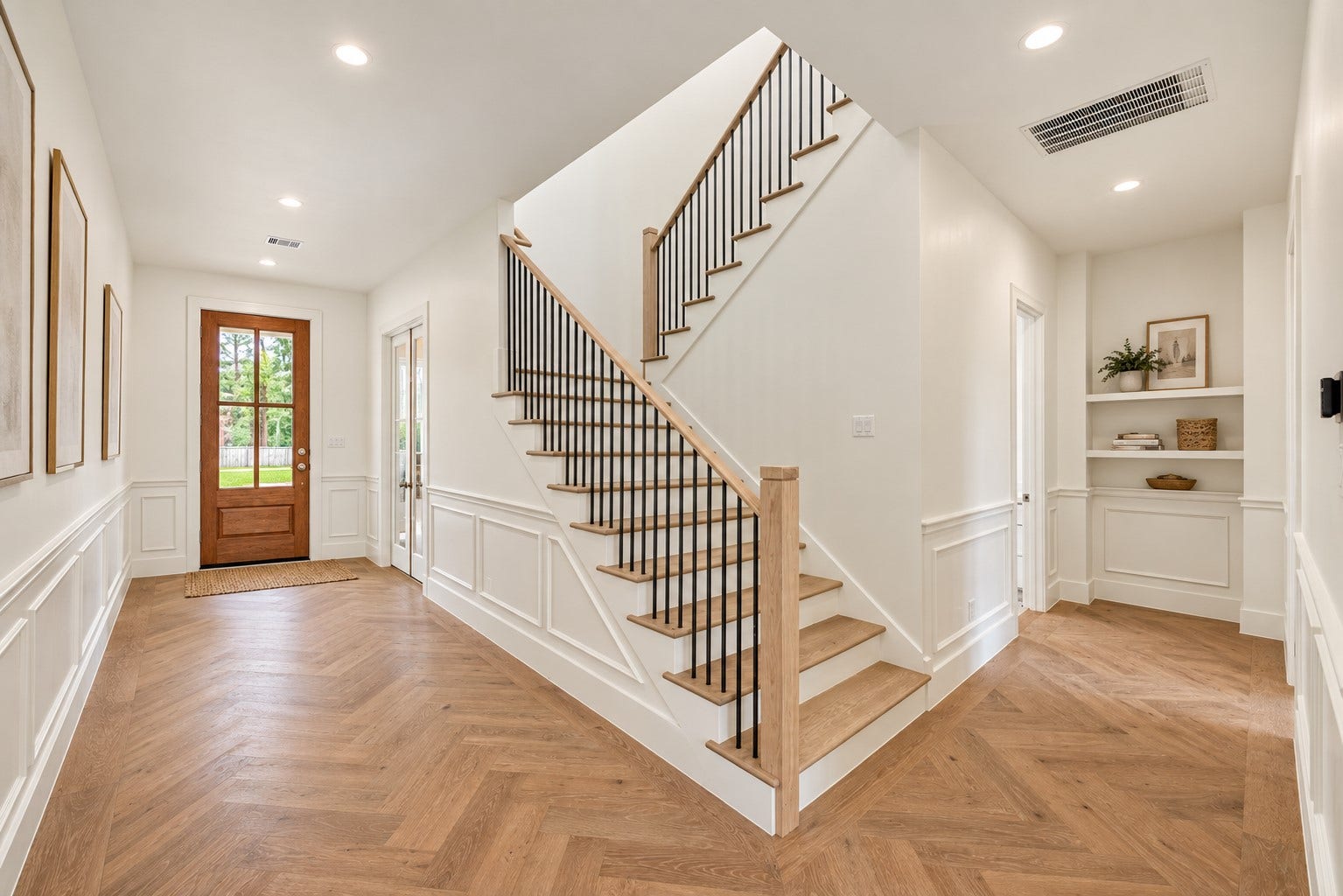 1726 Saxon Drive, Houston, TX 77018 The grand entryway showcases herringbone wood floors and custom millwork, with a formal study by the main entrance.