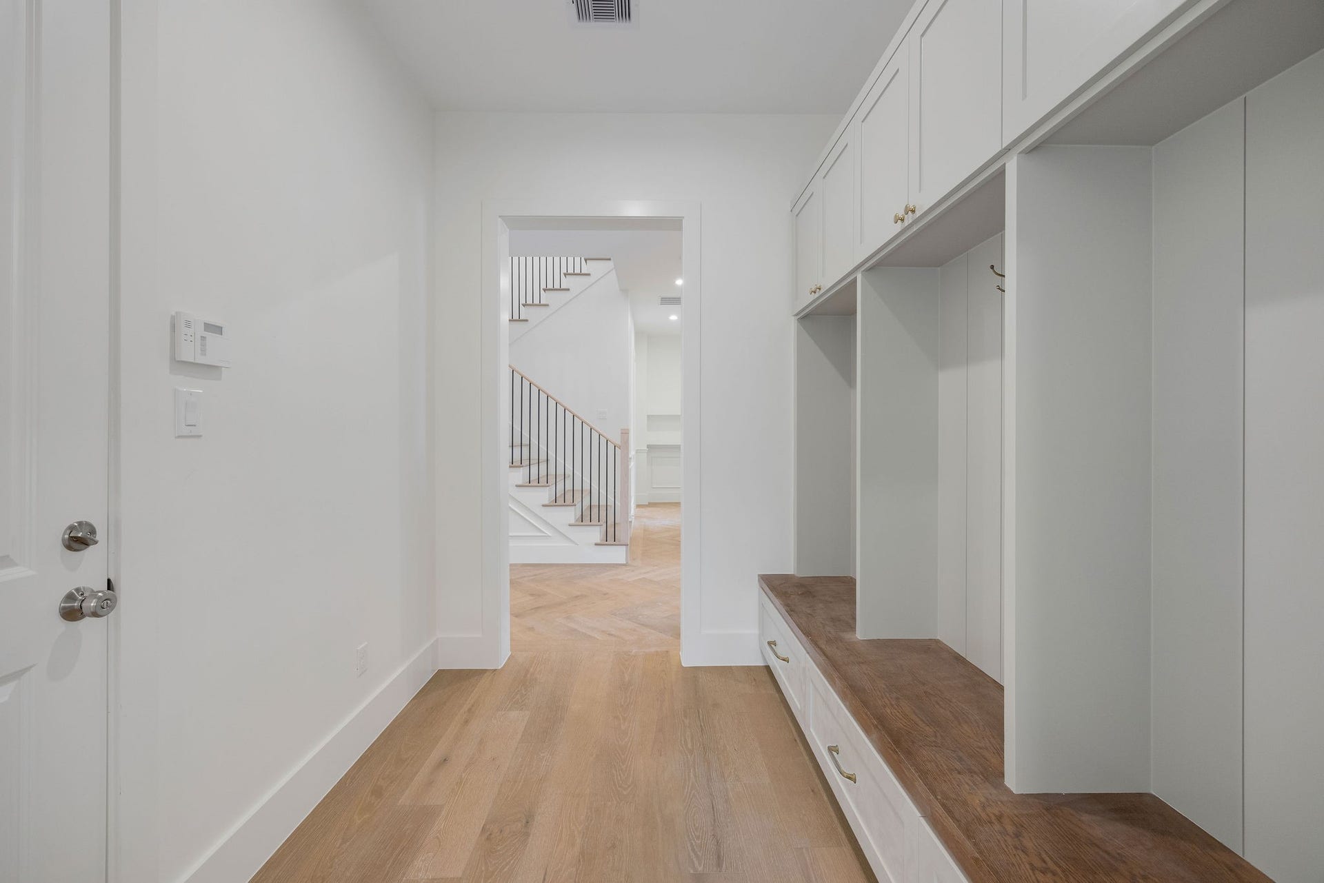 1726 Saxon Drive, Houston, TX 77018 The mud room provides a dedicated place for belongings. It connects to the scullery and entryway, creating a flowing layout throughout the home.