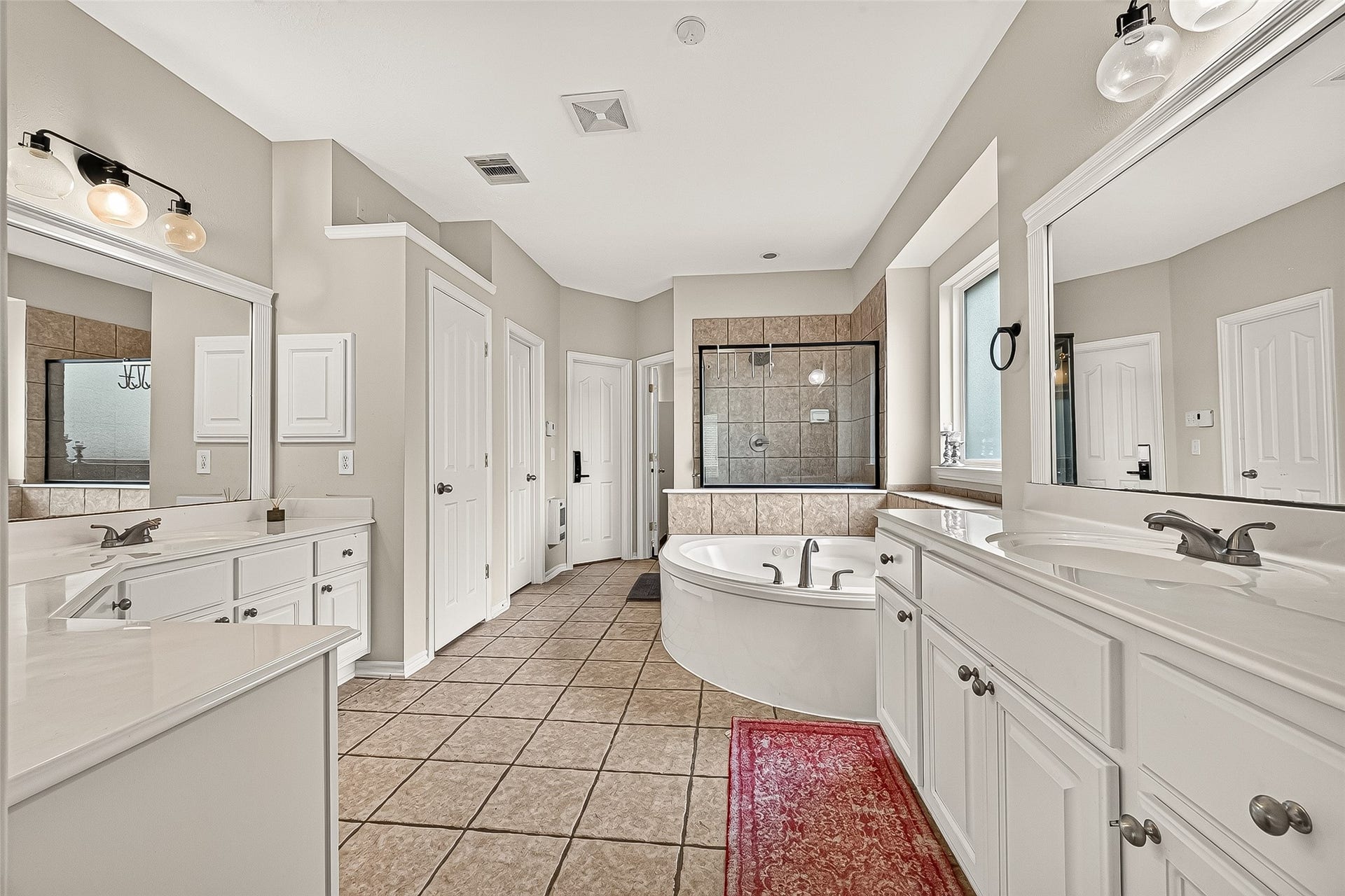 11603 Island Breeze Street, Pearland, TX 77584 Primary bath has a separate shower and soaking tub, two sinks and vanity area.