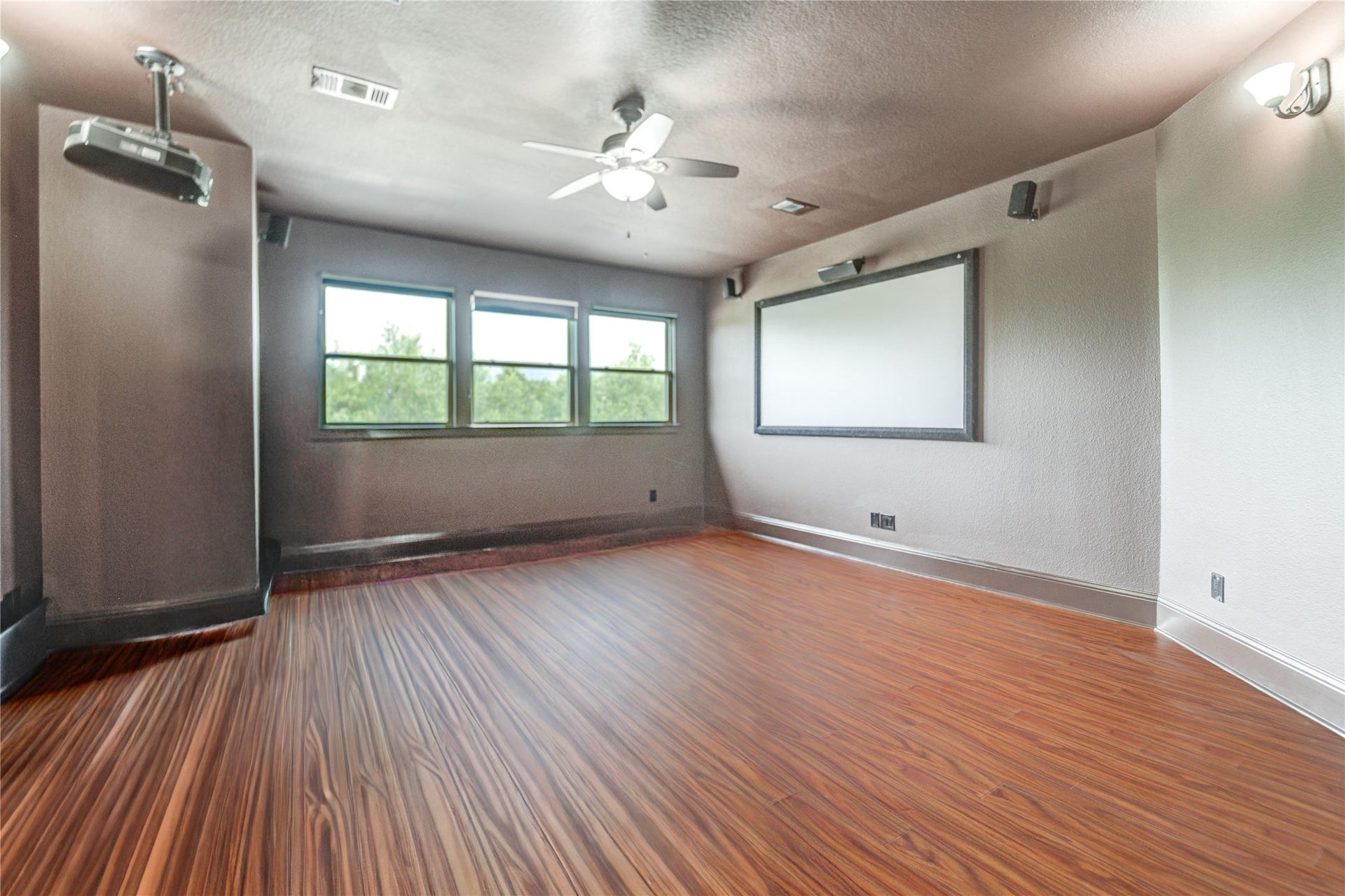 27715 Guthrie Ridge Ln, Katy, TX 77494 A luxurious second-floor media room, complete with a projector and large screen, perfect for cinematic entertainment.