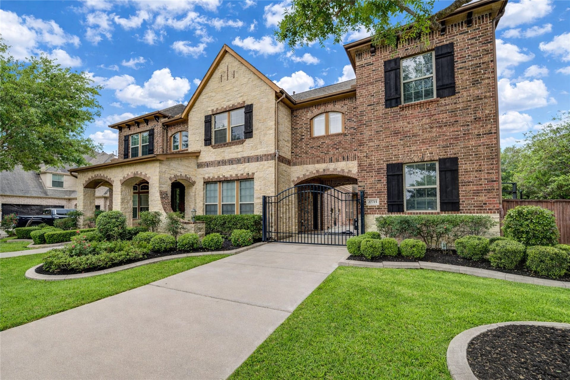 27715 Guthrie Ridge Ln, Katy, TX 77494 An elegant brick exterior complemented by a inviting front porch and a gated driveway for privacy and curb appeal.