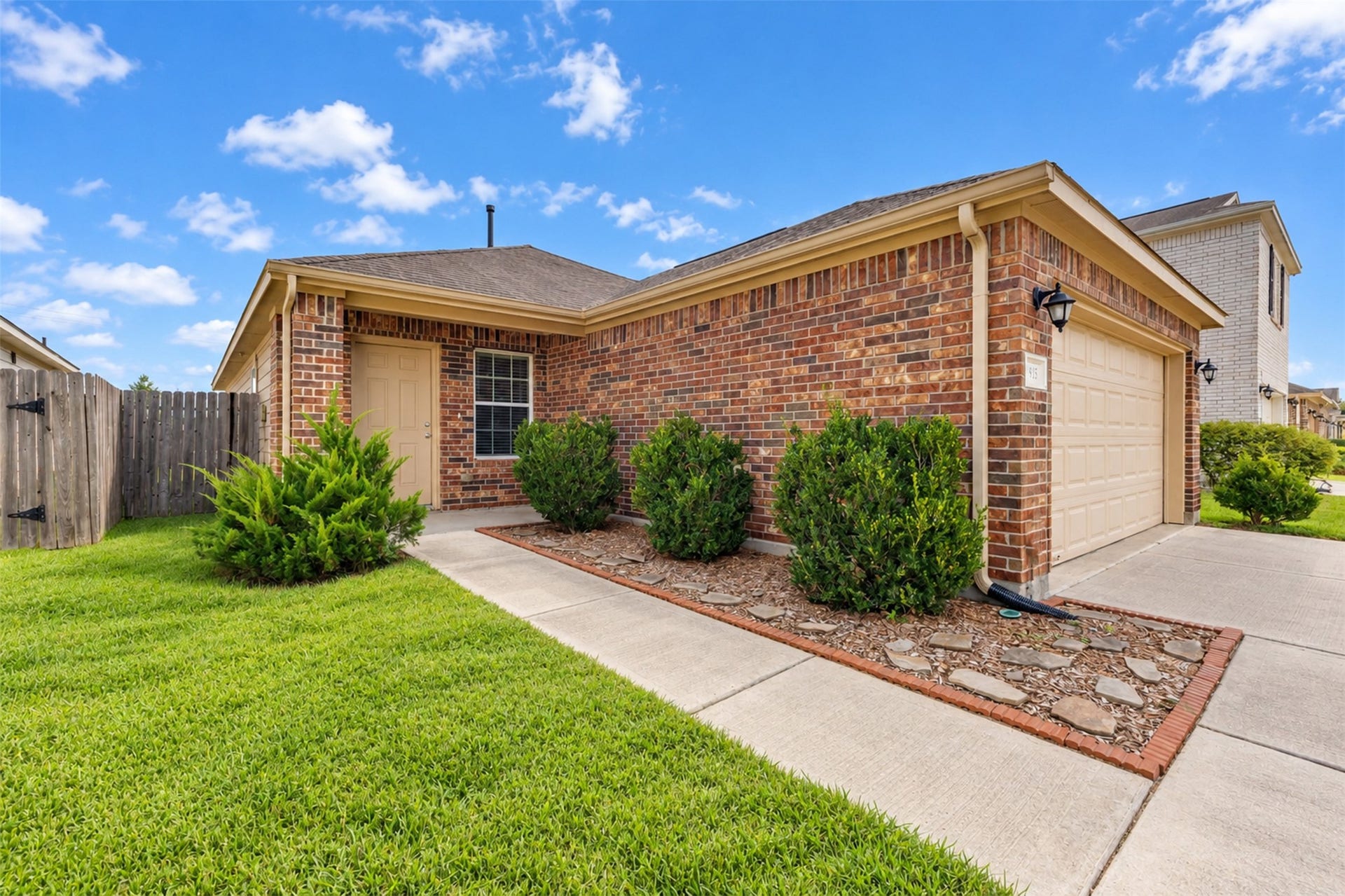 12915 Almeda Crossing Court, Houston, TX 77048 Attractive brick exterior with a welcoming covered entry, mature landscaping, and a well-maintained front lawn.