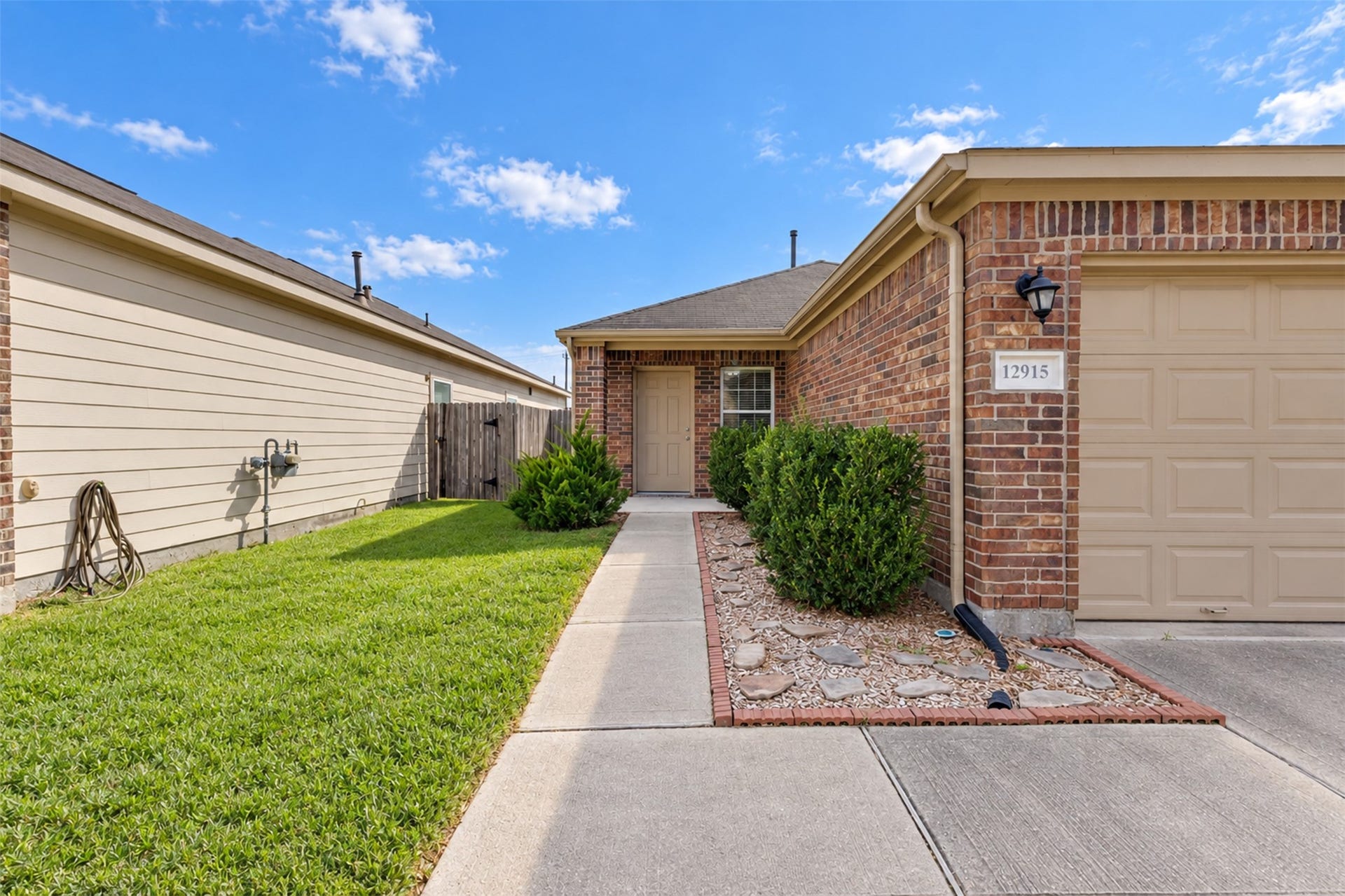 12915 Almeda Crossing Court, Houston, TX 77048 Welcoming front entrance with a covered entry, brick exterior, and mature landscaping.