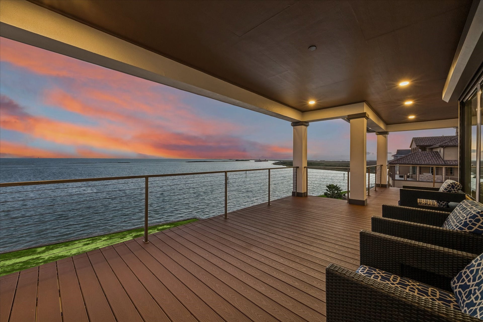 1 Water Key, Hitchcock, TX 77563 The spacious covered balcony just off the main living area offers unobstructed views of West Galveston Bay. New composite decking provides a lifetime of low maintenance, while sleek cable railings and a covered ceiling with recessed lighting create a stylish, all-weather outdoor space
