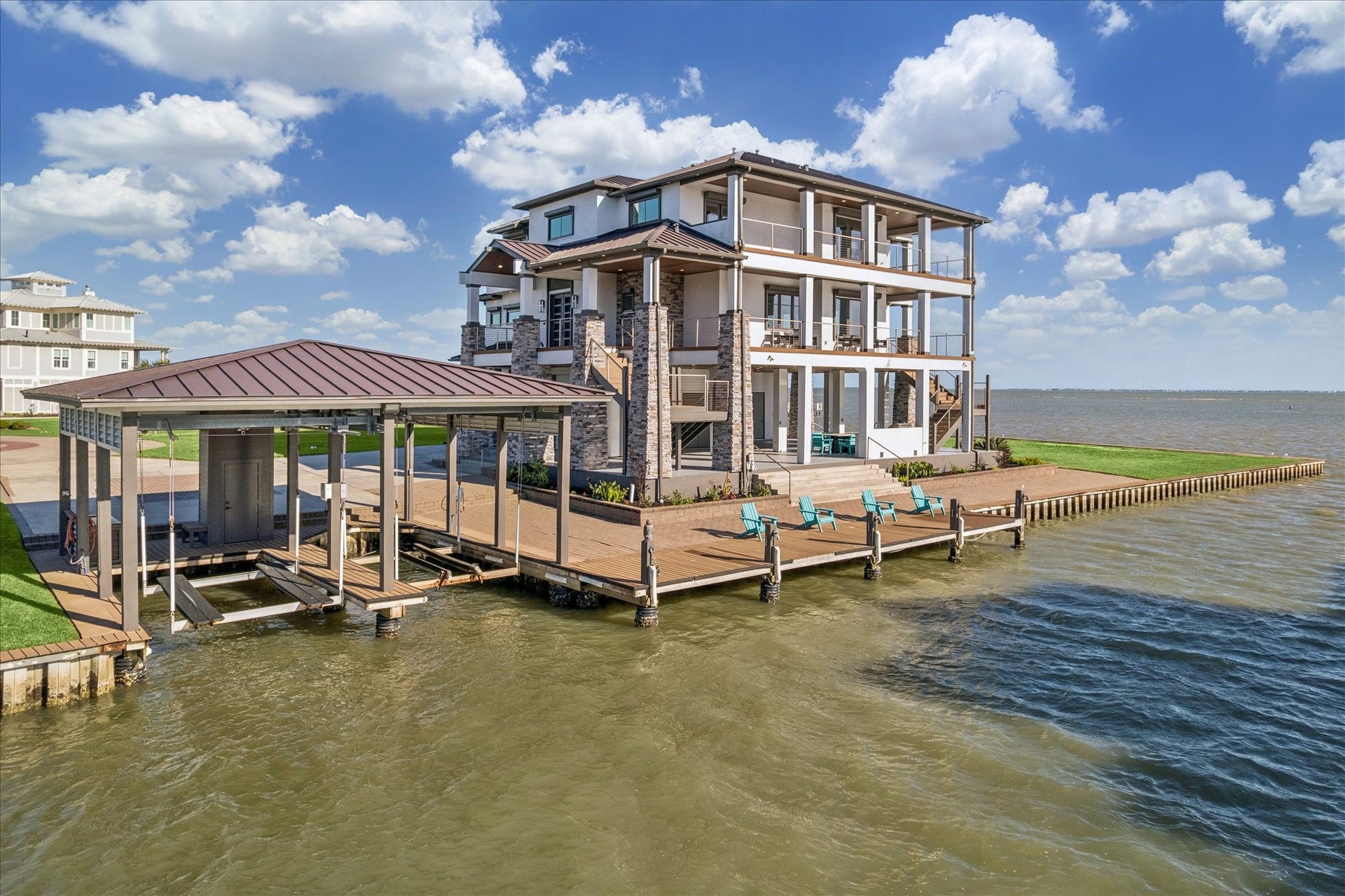 1 Water Key, Hitchcock, TX 77563 This modern retreat offers unobstructed views of West Galveston Bay and the Intracoastal Waterway from expansive multi-level covered balconies. Designed for boating enthusiasts, it features a private double boathouse with lifts and a pier with a lounge dock. The prime waterfront setting completes this exceptional Harborwalk sanctuary
