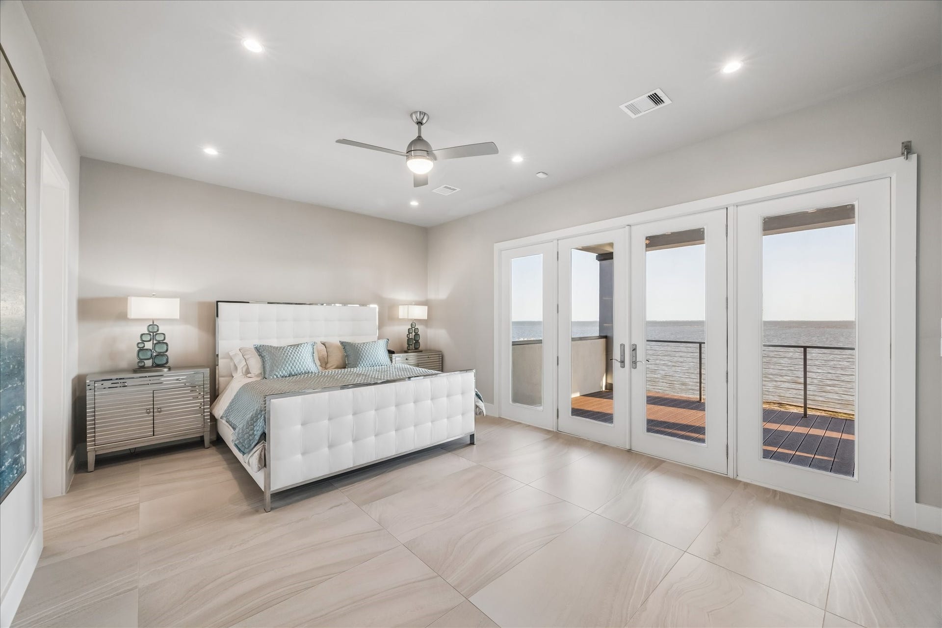 1 Water Key, Hitchcock, TX 77563 Step into the serene primary suite designed as a true sanctuary, where French doors open directly onto a the covered balcony for waking up to panoramic bay views