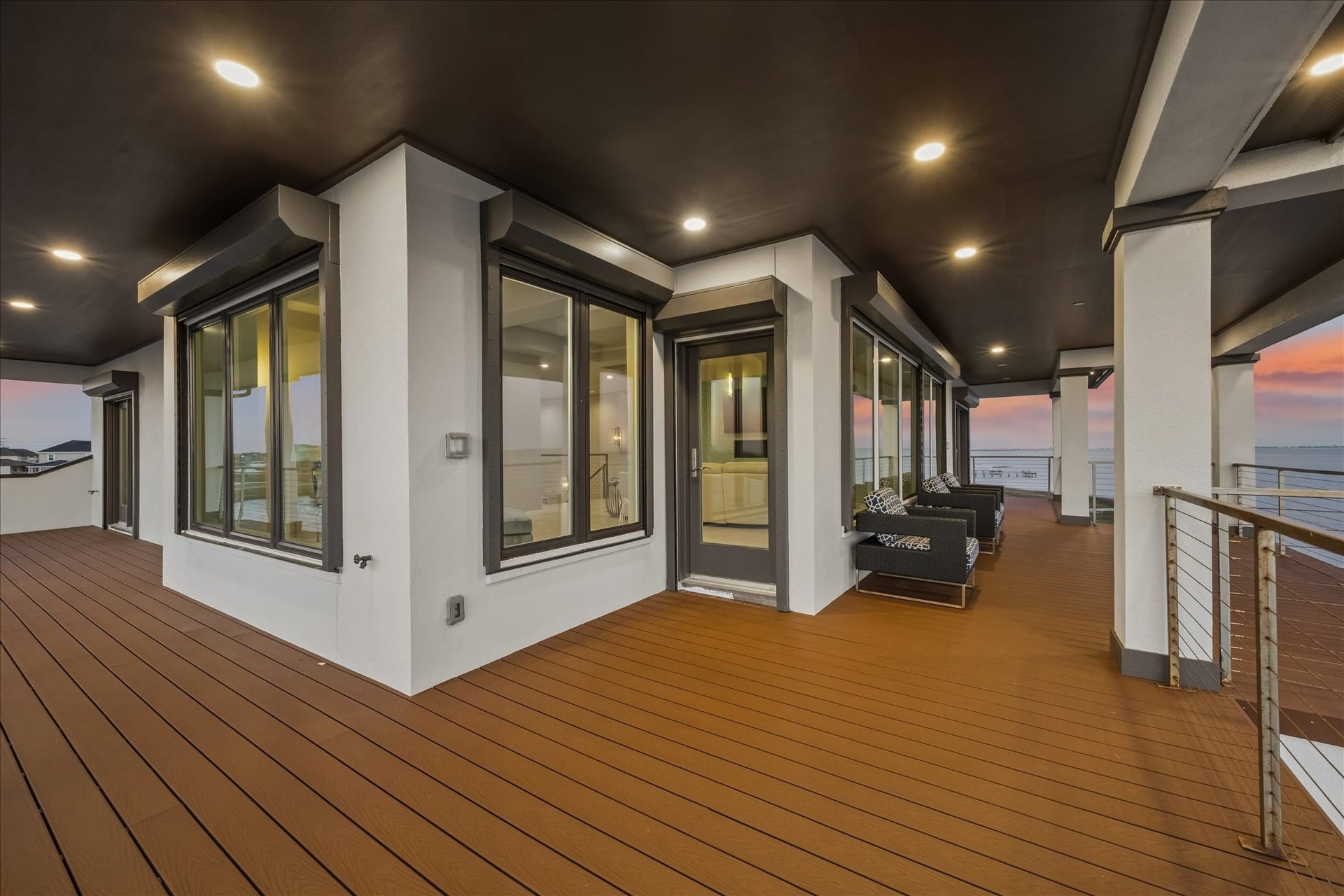1 Water Key, Hitchcock, TX 77563 This extraordinary balcony provides a seamless transition from the second-level living area to an incredible waterfront setting, with all windows outfitted with motorized storm shutters for both protection and privacy